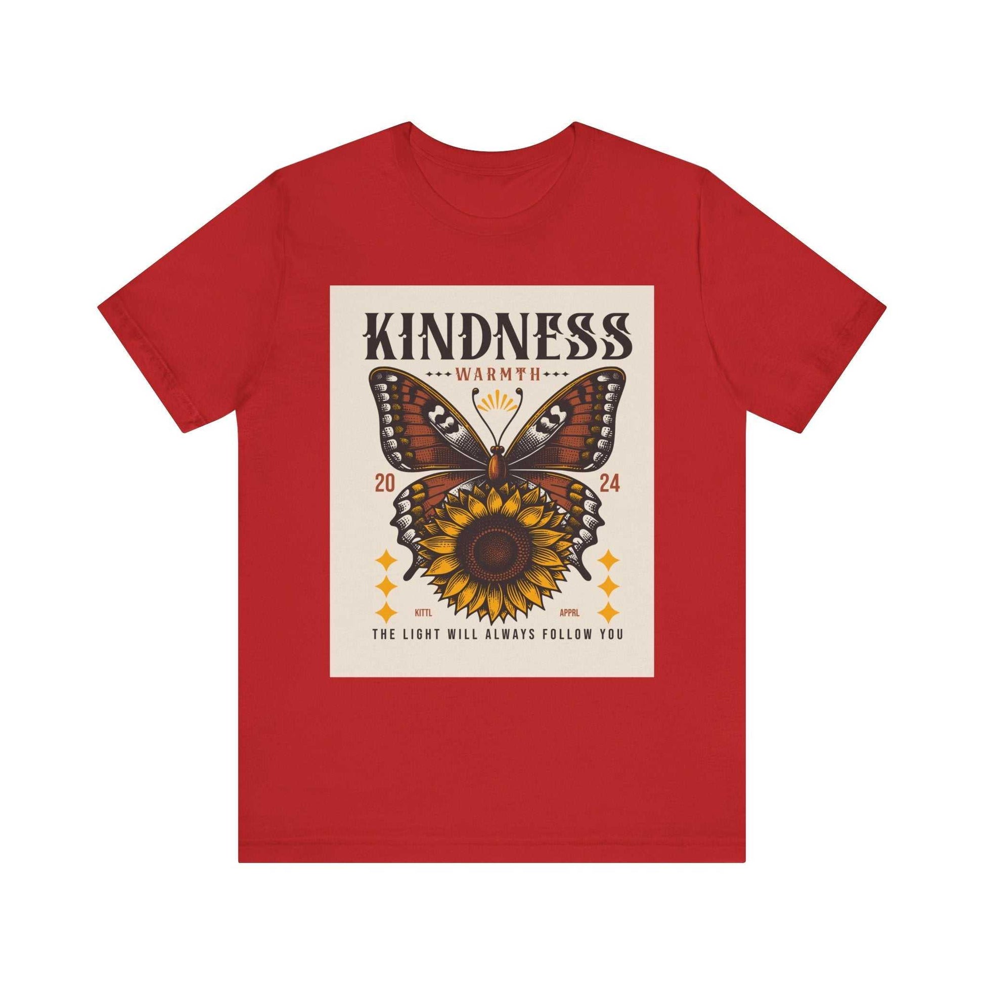 Red Kindness Butterfly Tee featuring a butterfly and sunflower design with the text "Kindness Warmth 2024" and "The light will always follow you" on a unisex short sleeve shirt.
