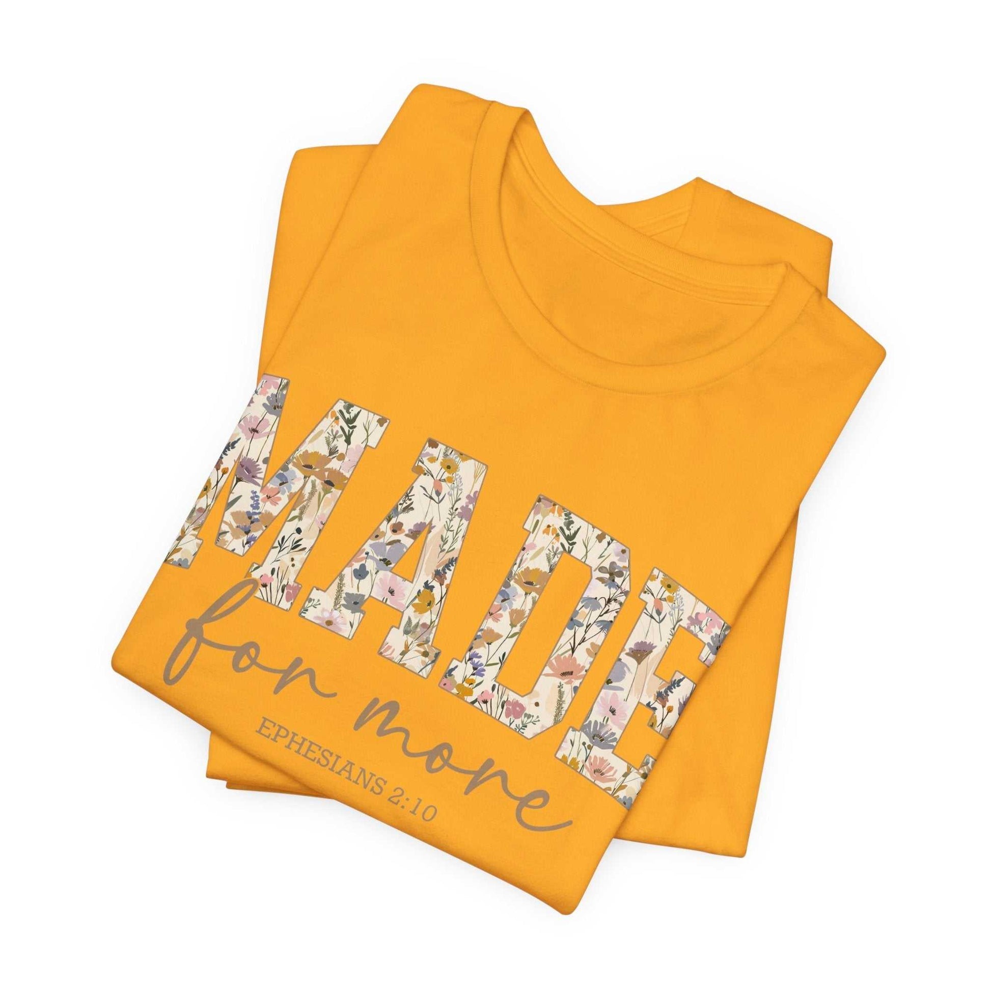Yellow Made for More Tee with floral patterned text and Bible verse Ephesians 2:10 printed on front, folded flat