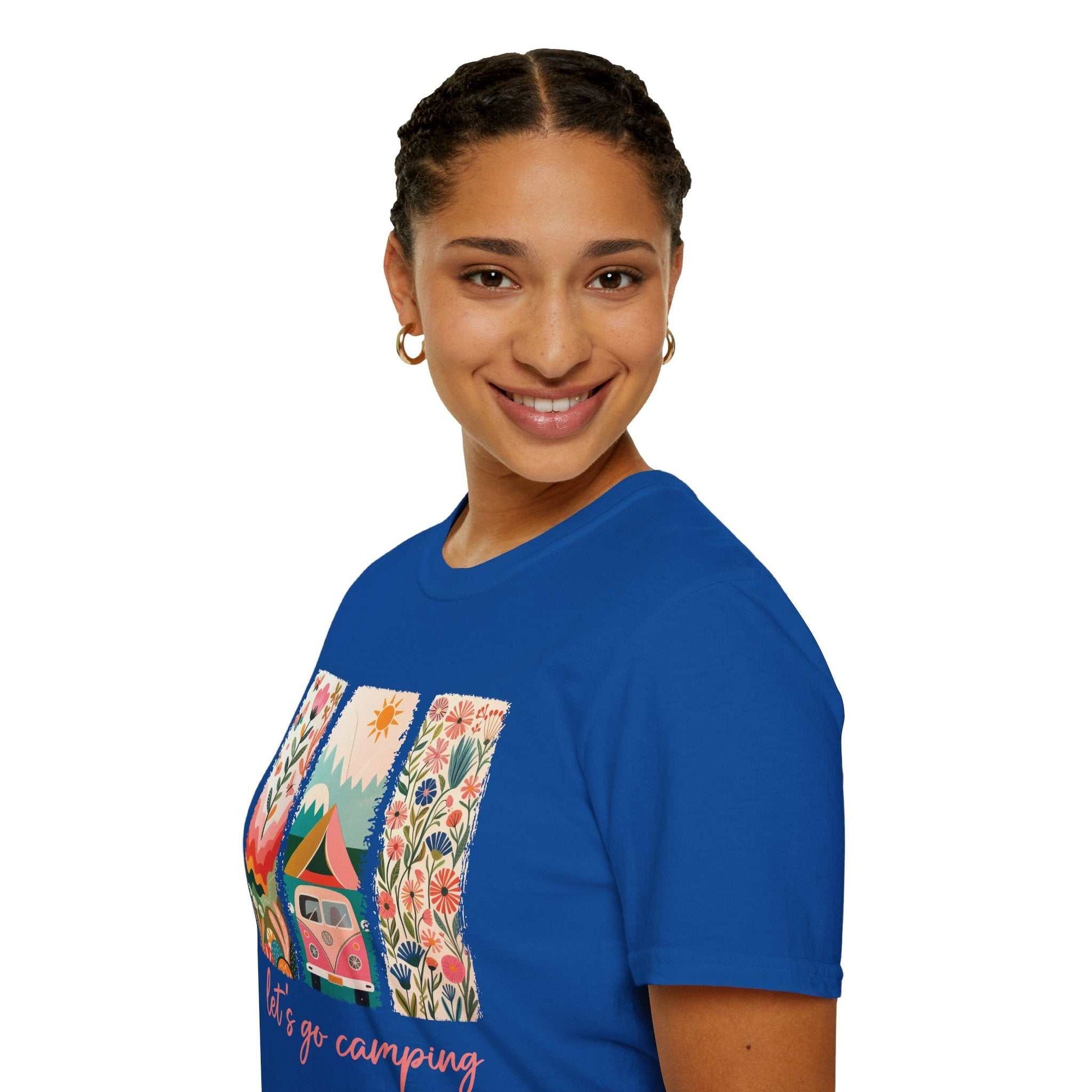 Woman wearing blue Camping Adventure unisex softstyle t-shirt with colorful camper van and floral design