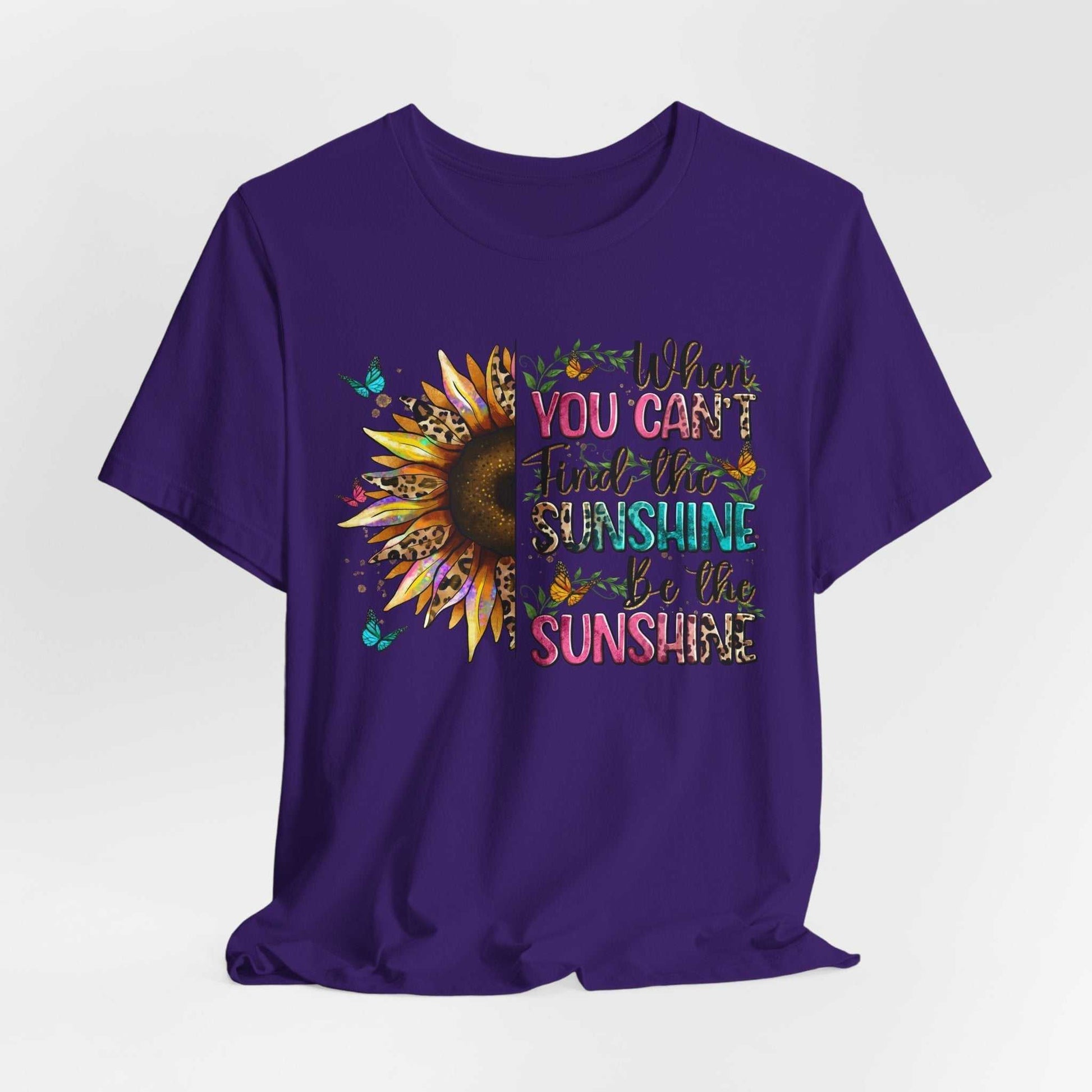 Purple unisex tee with sunflower and inspirational "When you can't find the sunshine be the sunshine" quote design