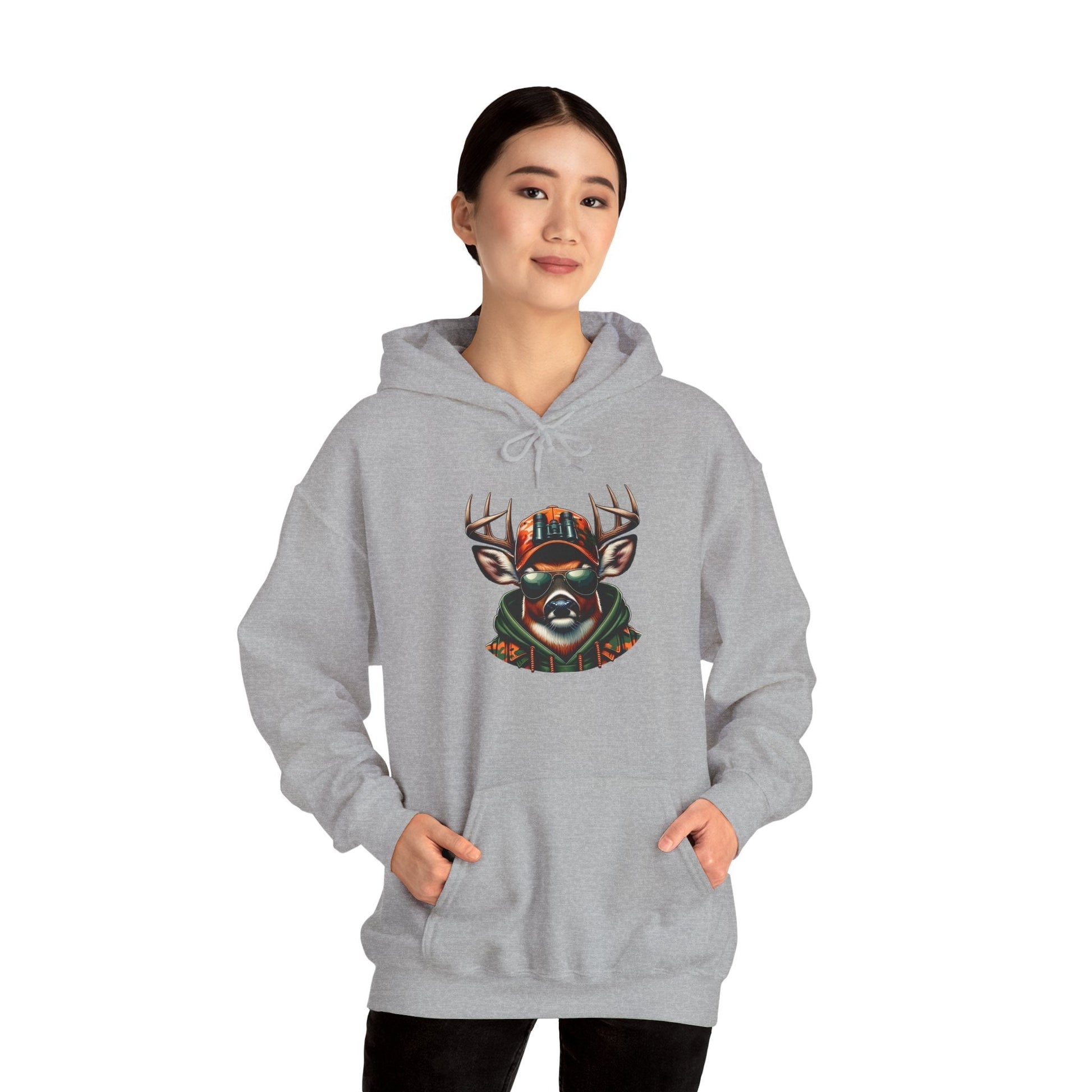 Woman wearing grey hooded sweatshirt with bold colorful deer graphic on front and kangaroo pocket