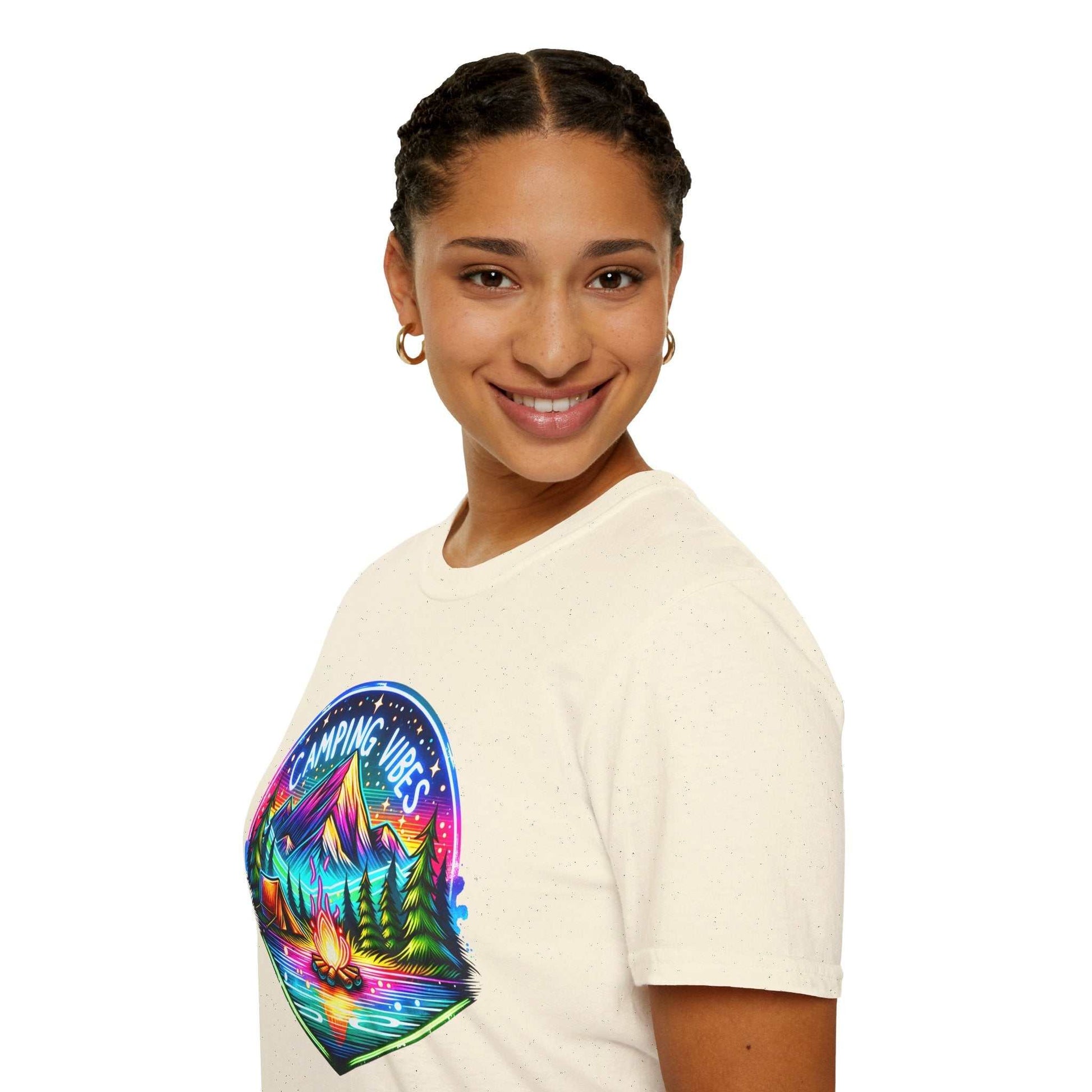 Woman wearing beige unisex softstyle t-shirt with colorful Camping Vibes mountain and campfire design