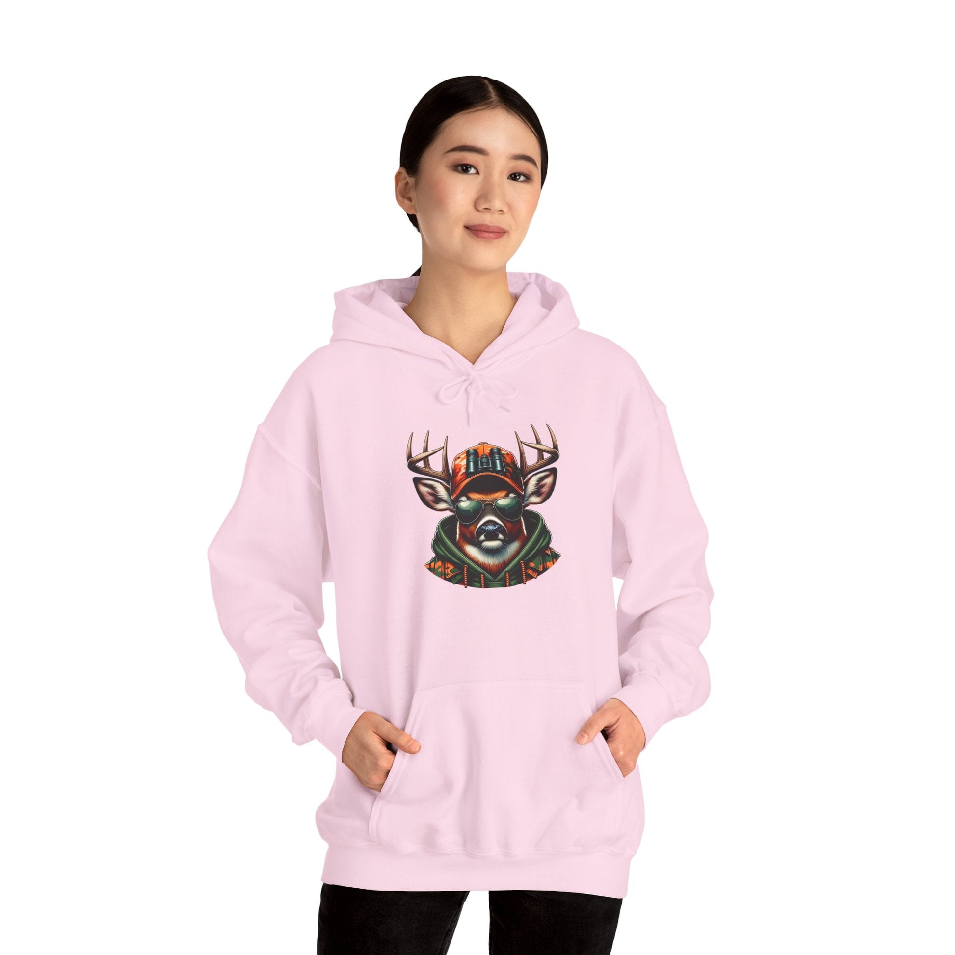woman wearing light pink hooded sweatshirt with bold colorful deer graphic design and front kangaroo pocket