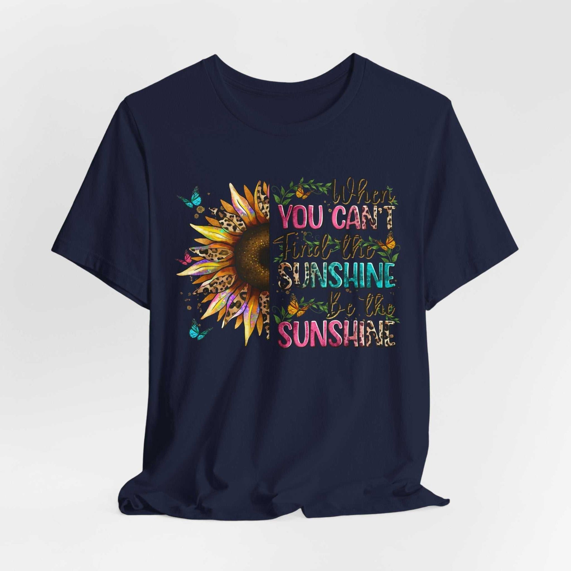Navy blue unisex tee with vibrant sunflower and inspirational sunshine quote design on front