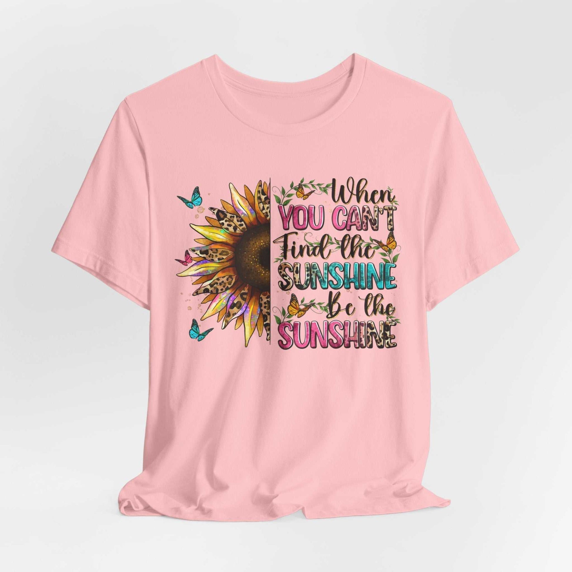 Pink Sunshine Quote Tee with sunflower and butterfly design and uplifting text "When you can't find the sunshine be the sunshine"