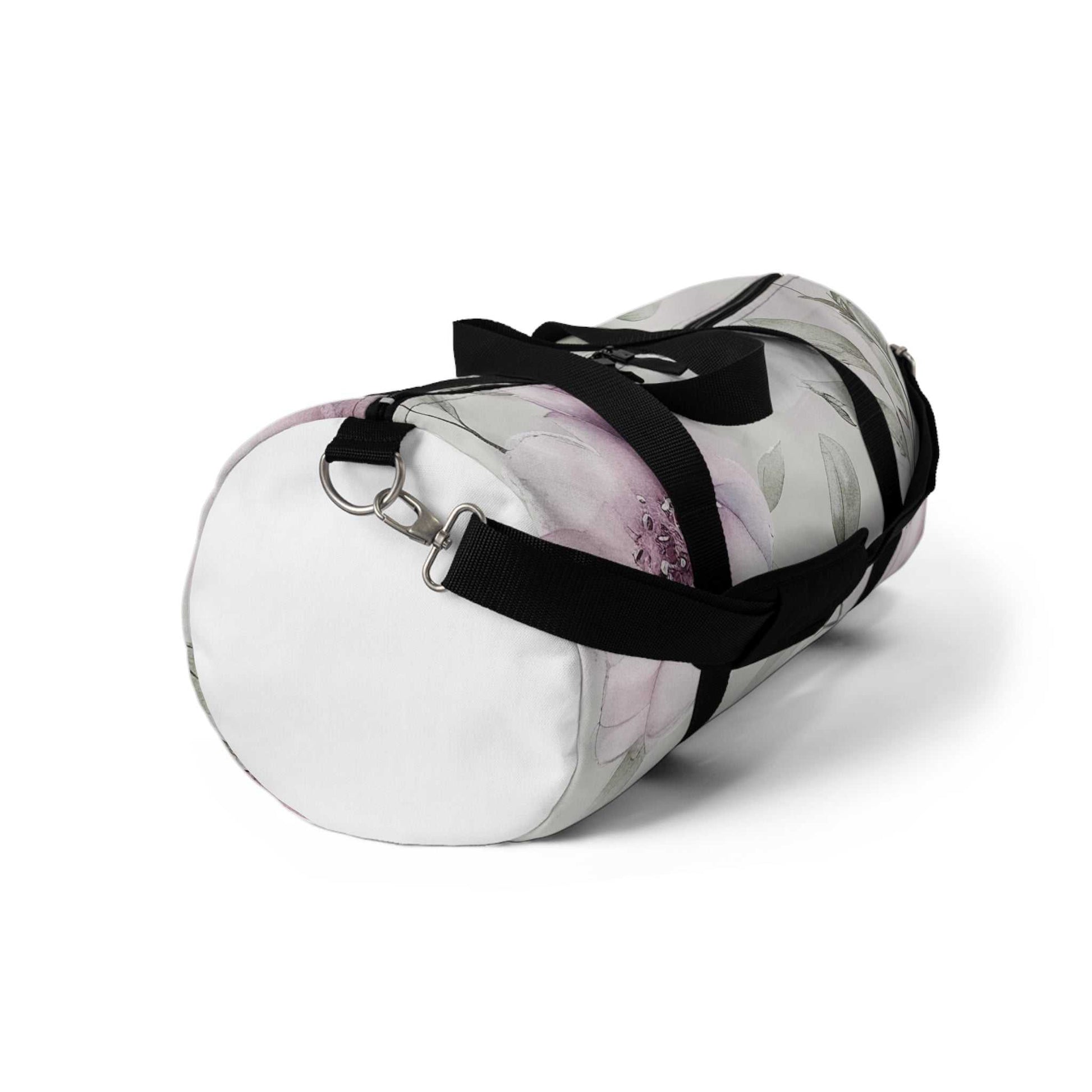 Small floral pattern duffel bag with black adjustable strap and zipper closure, made of durable polyester