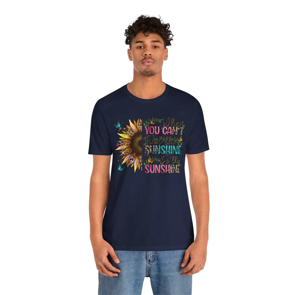 Man wearing navy Sunshine Quote Tee with colorful sunflower and positive quote design on front