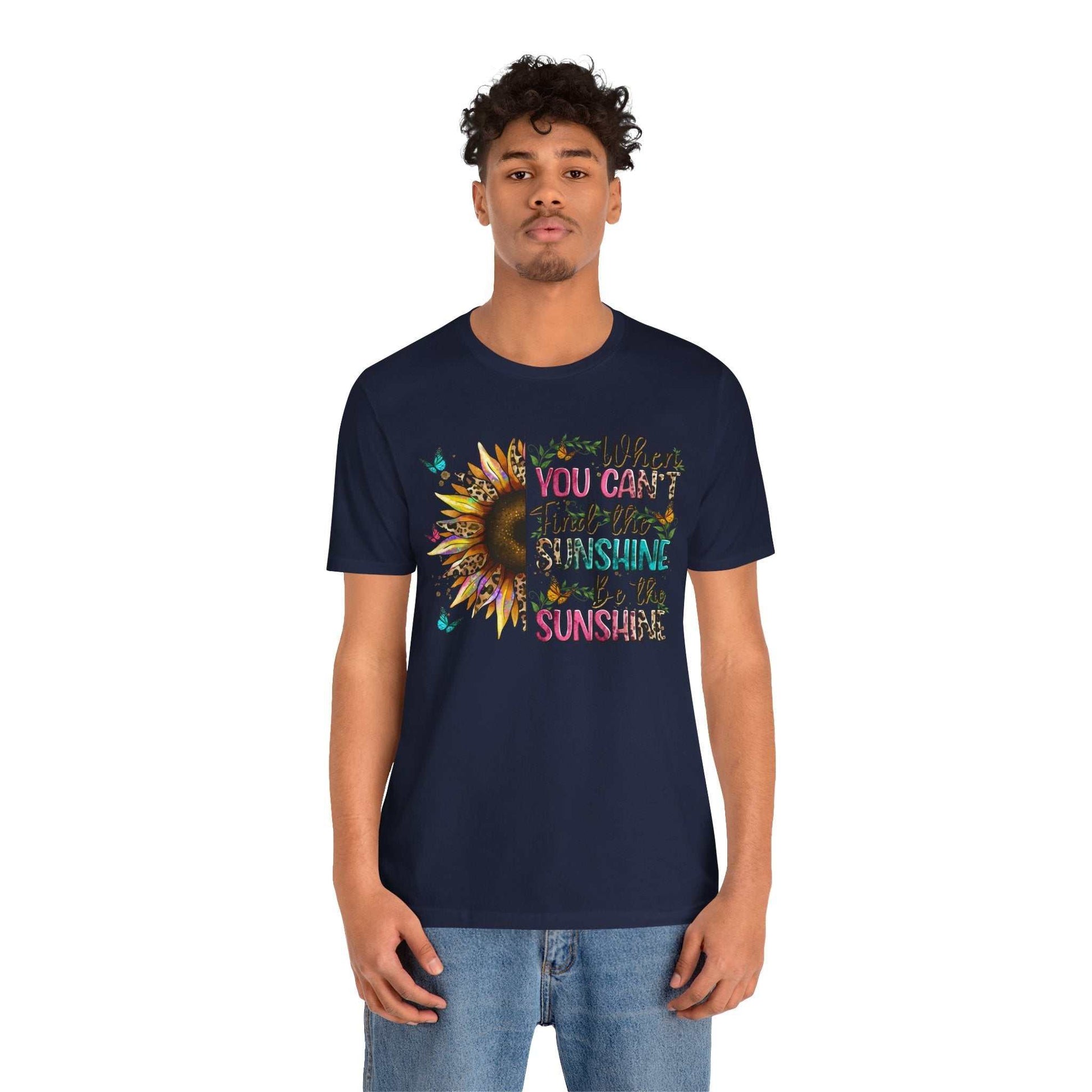 Man wearing navy Sunshine Quote Tee with colorful sunflower and positive quote design on front