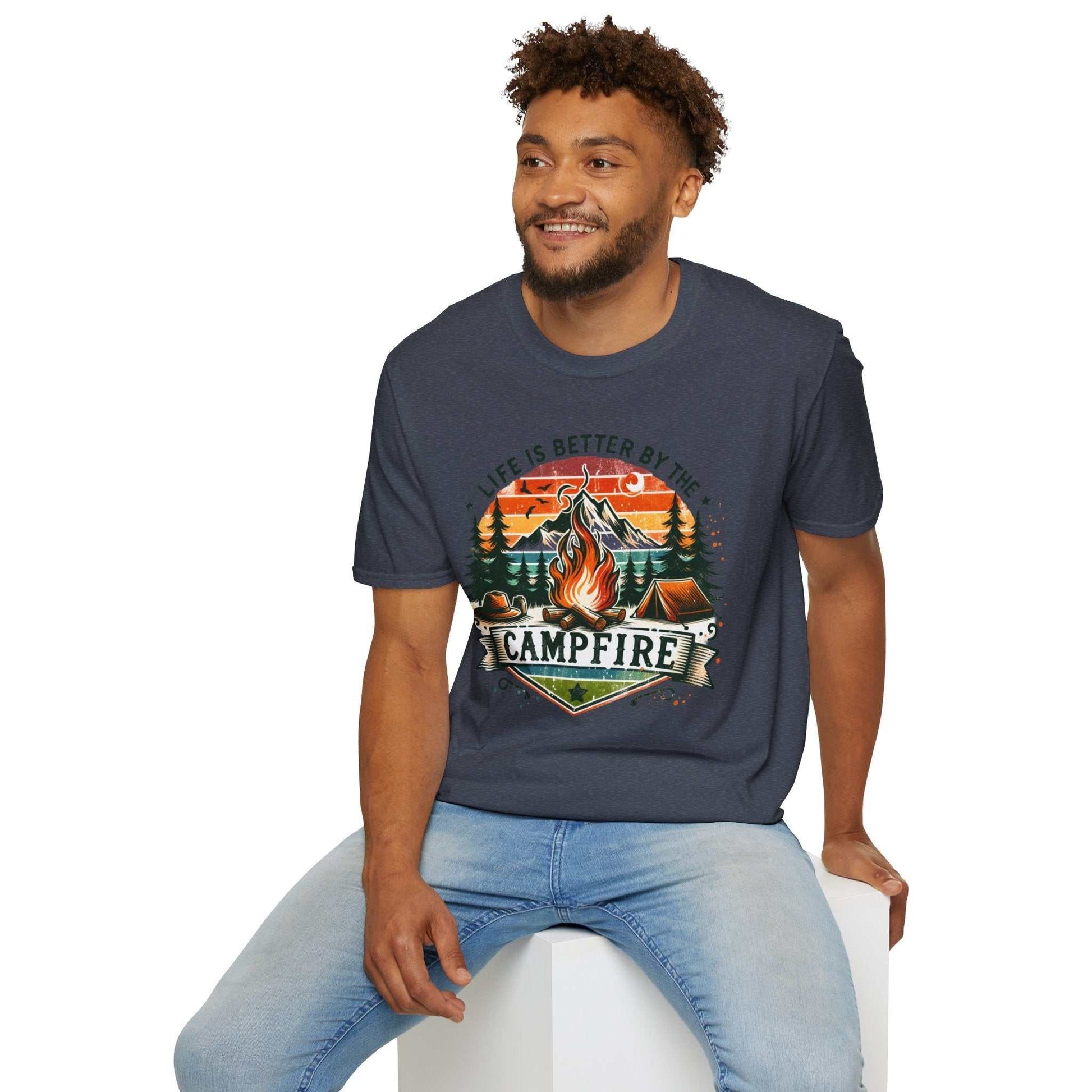 Man wearing navy unisex Camping Adventure T-Shirt with "Life is Better by the Campfire" graphic and campfire design.