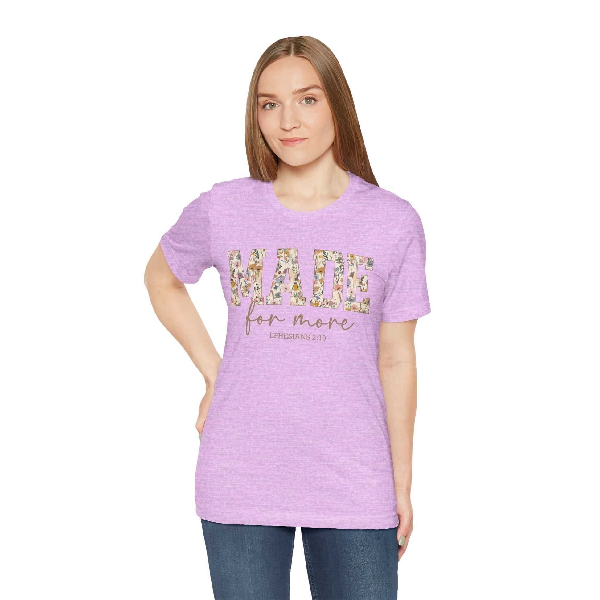 Woman wearing lavender Made for More Tee with floral text design, casual fit, short sleeves, and crew neck