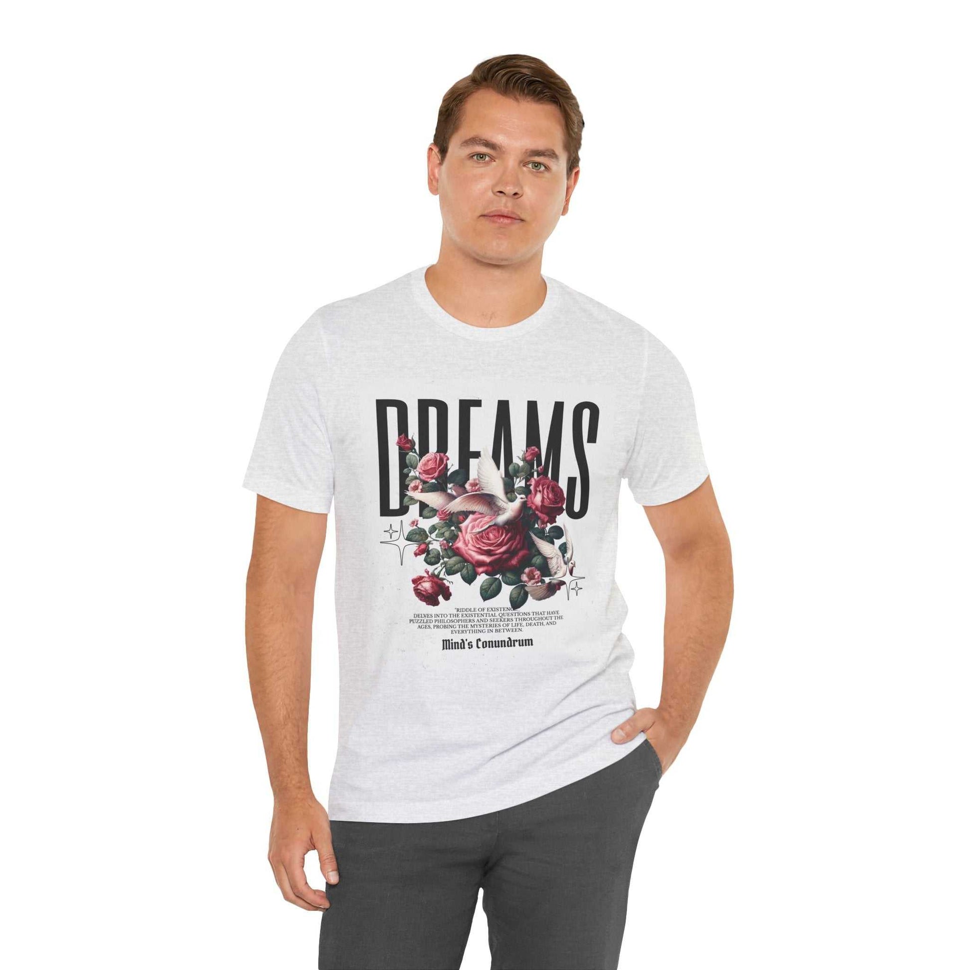 Man wearing white Dreams Floral Tee with rose graphic and bold typography on front