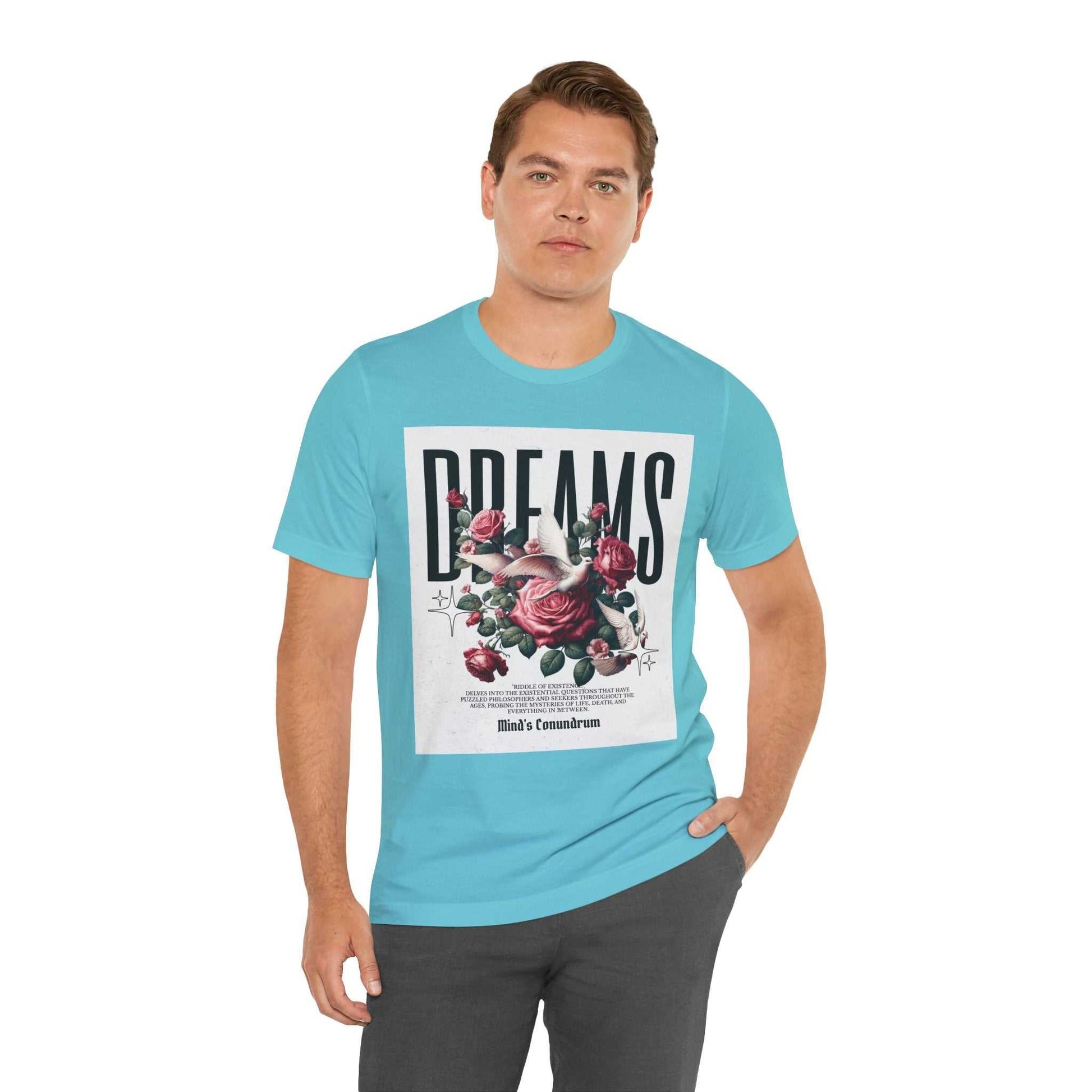 Man wearing blue Dreams Floral Tee with large floral and typography print on front