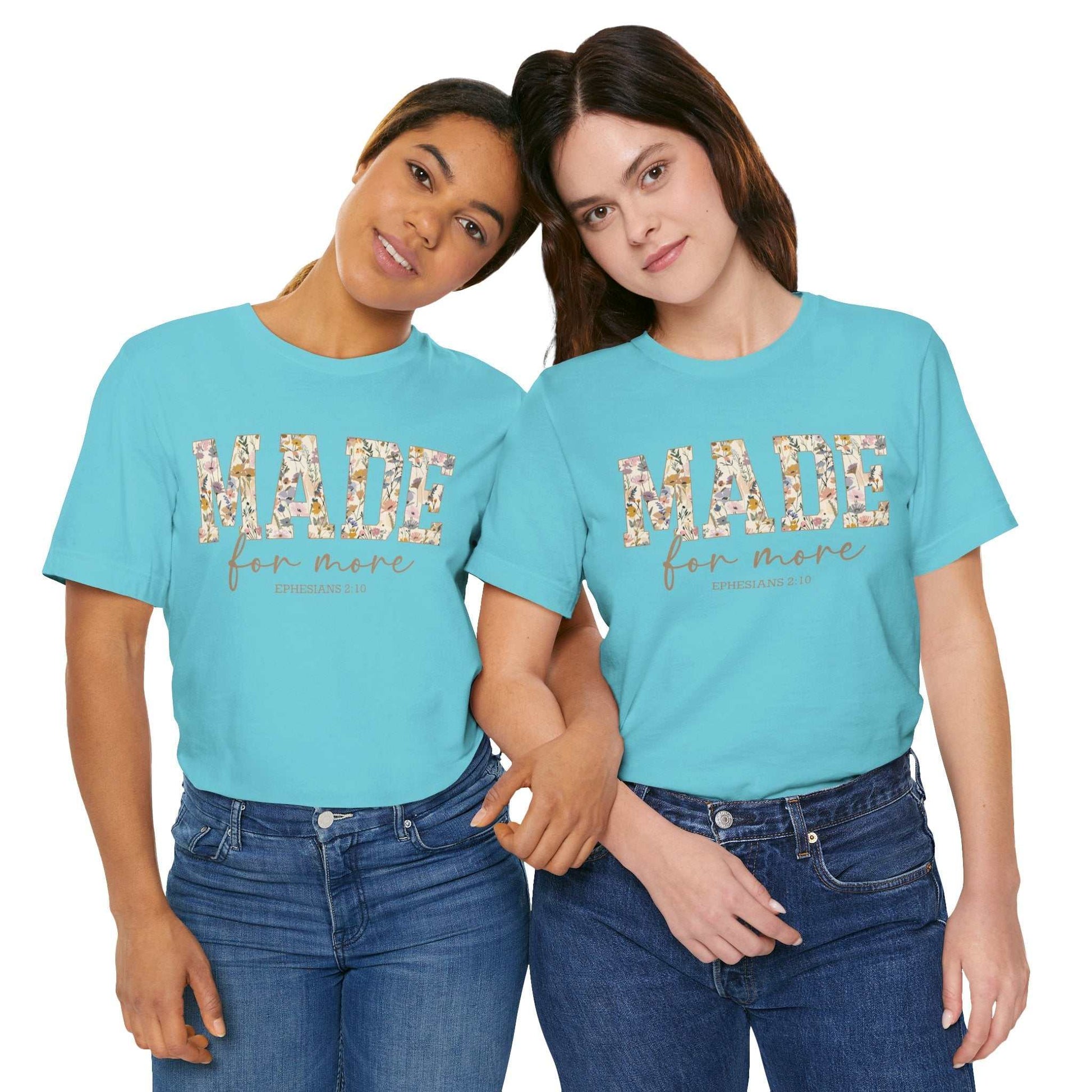 Two women wearing light blue Made for More Tee shirts with floral text design, casual fit, styled with jeans.