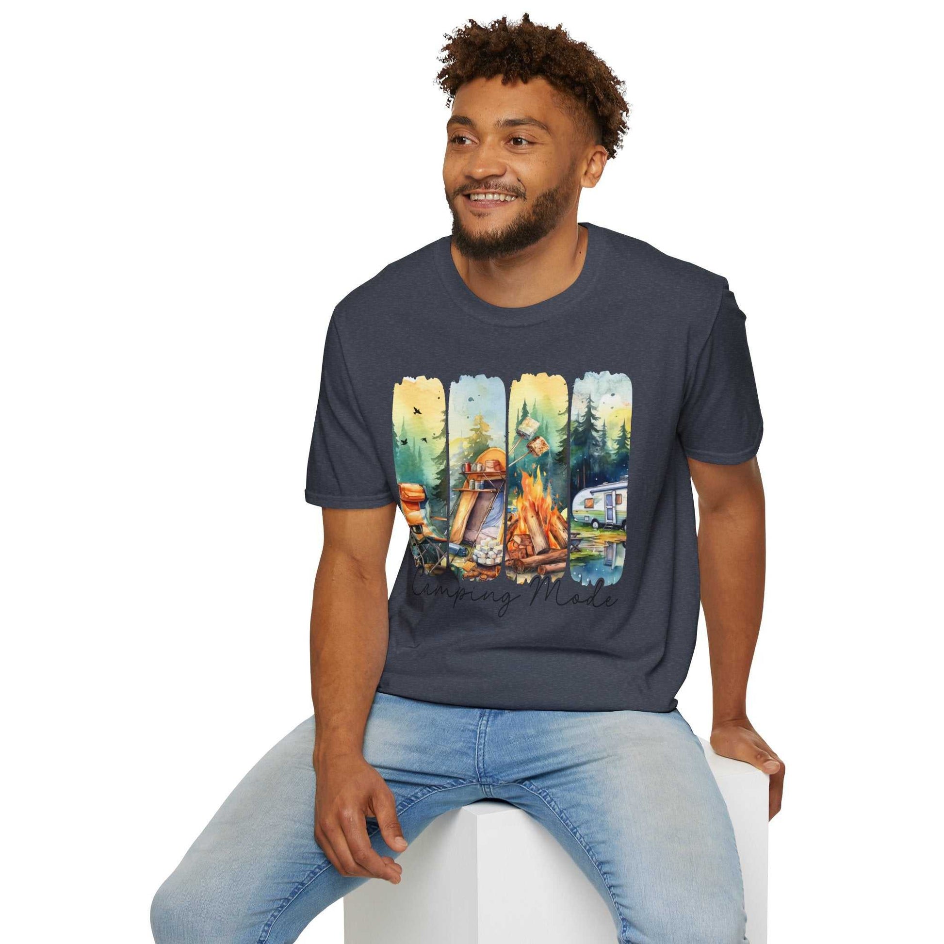 Man wearing navy Camping Adventure Unisex T-Shirt with colorful camping-themed graphic sitting on white block