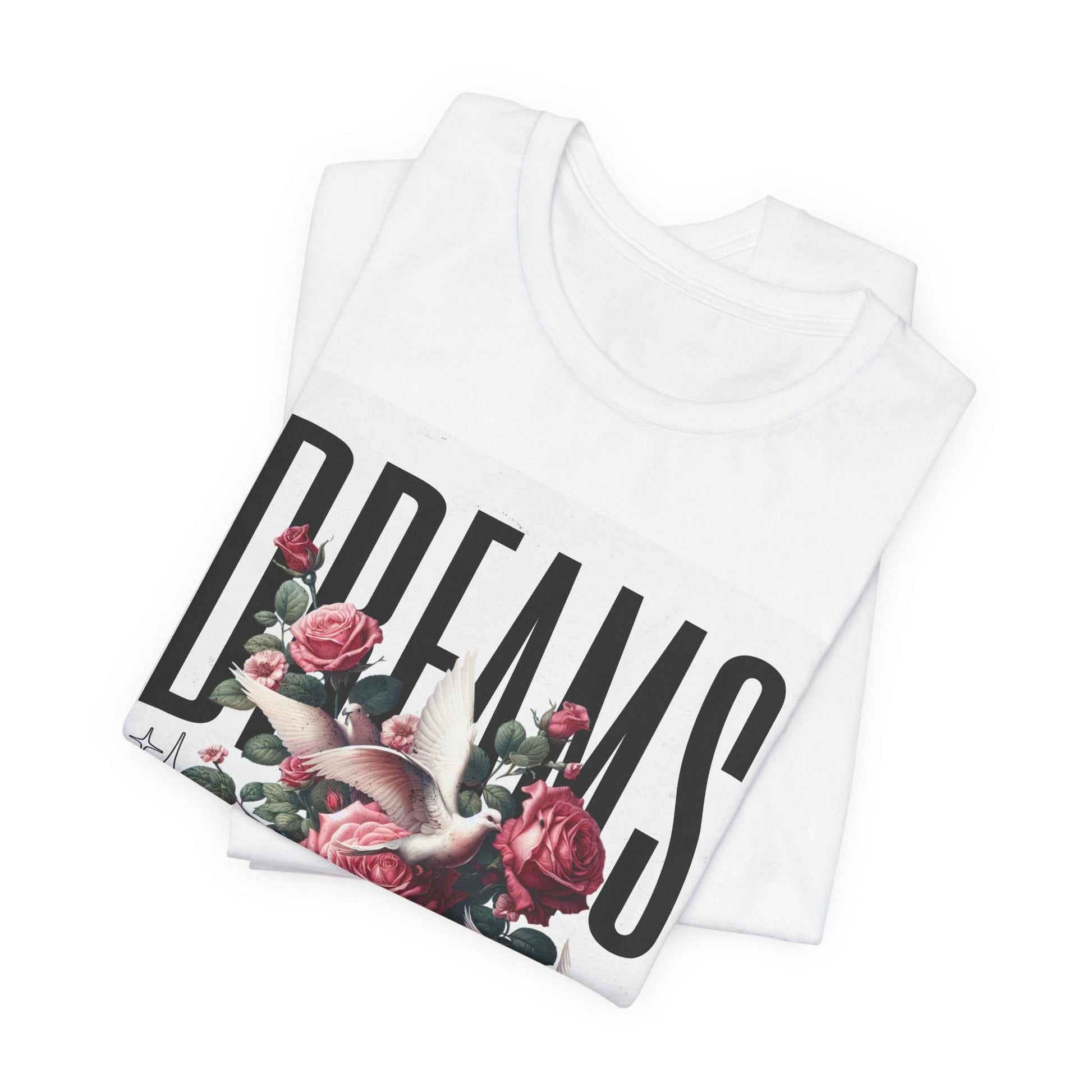 White Dreams Floral Tee with large black "DREAMS" text, pink roses, and a white dove graphic.