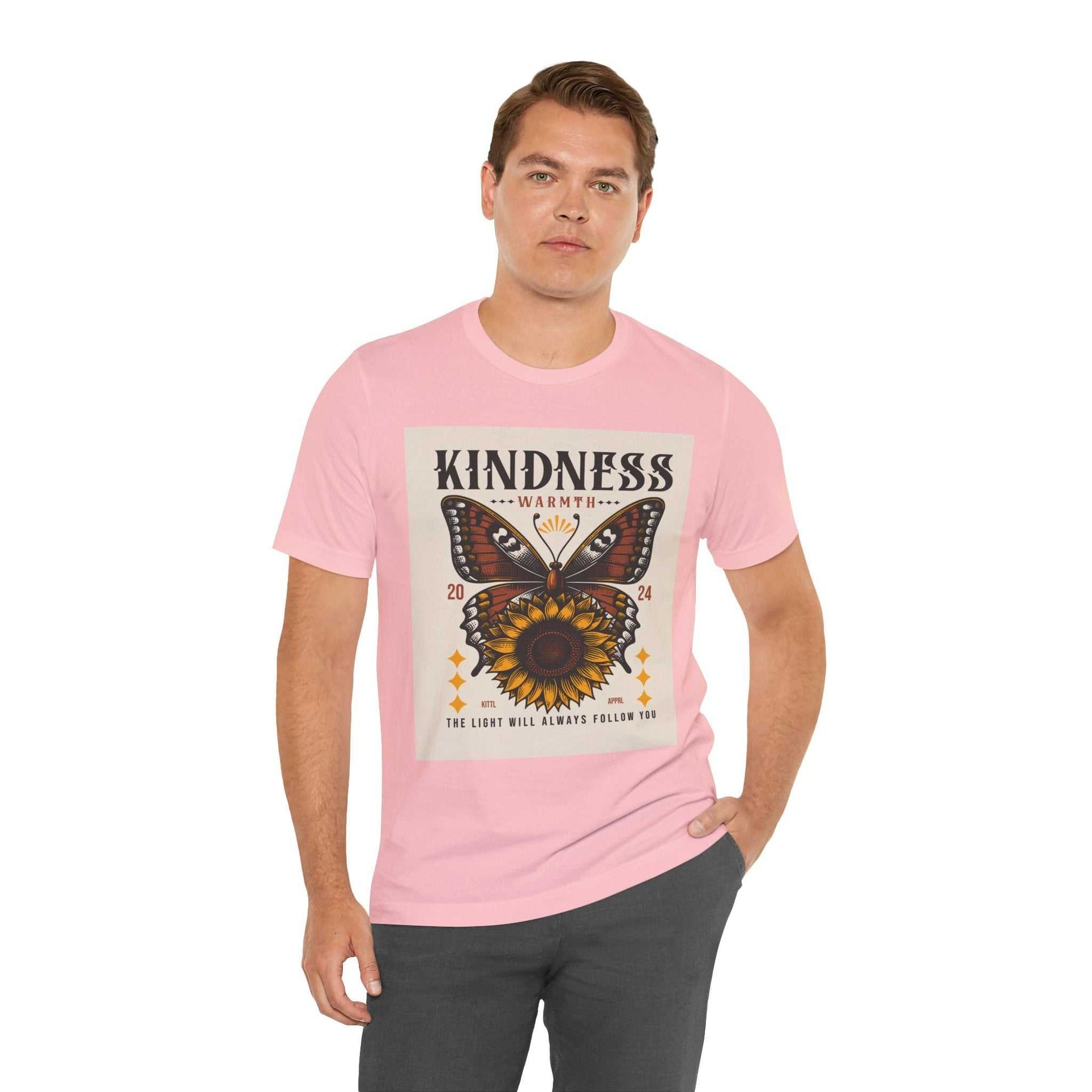 Man wearing pink Kindness Butterfly Tee with butterfly and sunflower graphic and kindness message