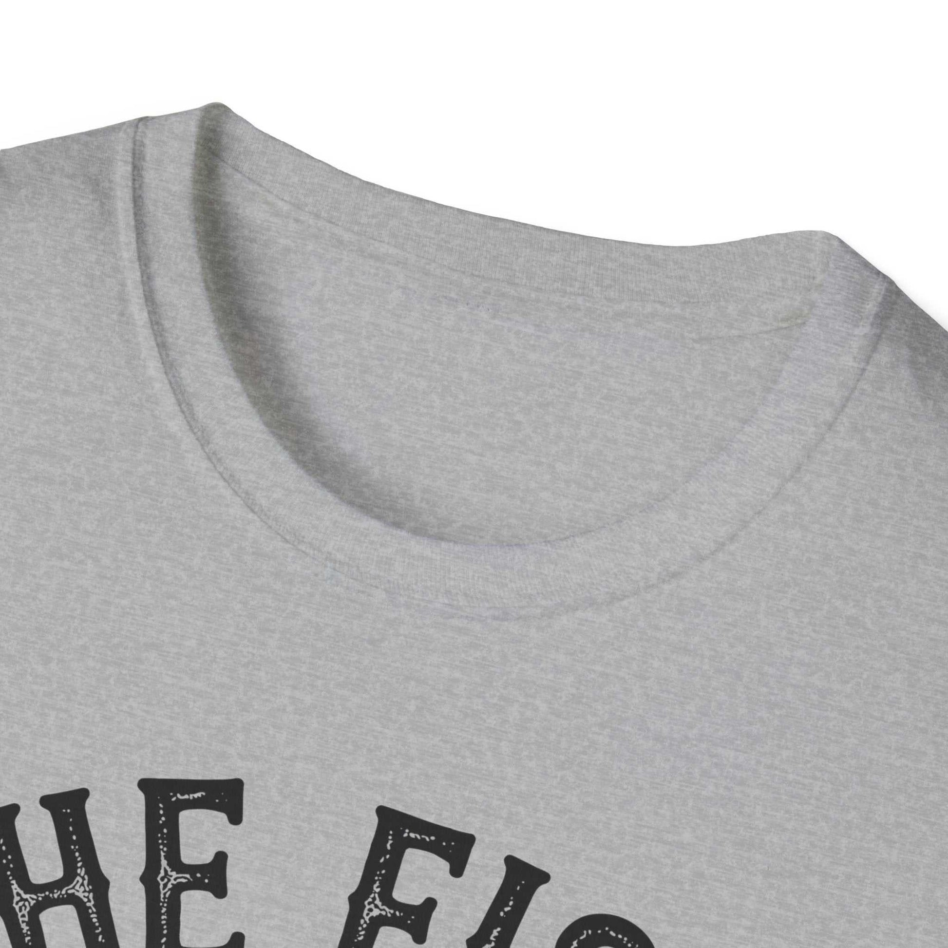 Close-up of grey unisex softstyle t-shirt featuring "The Fish Whisperer" printed text on front