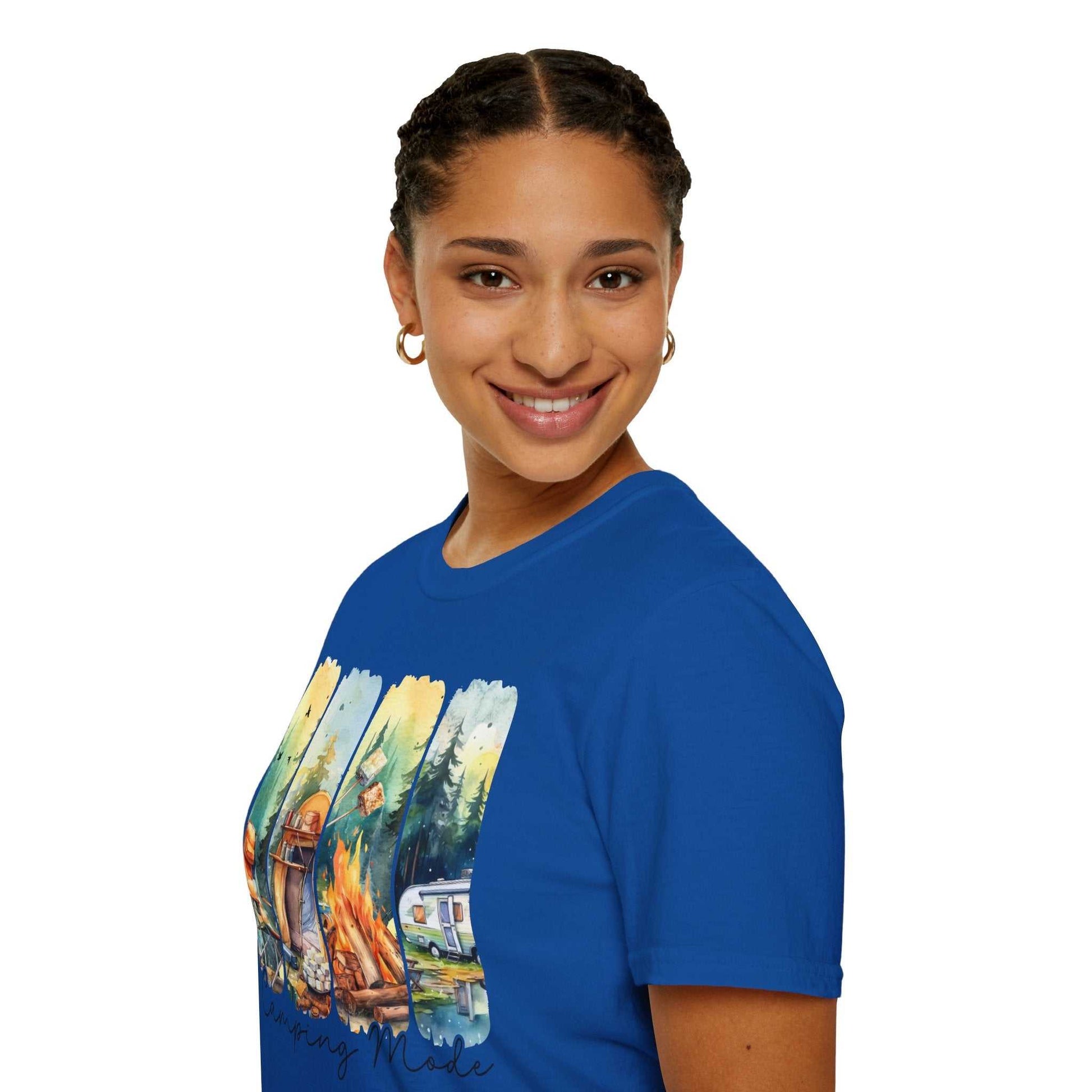 Smiling woman wearing a blue Camping Adventure Unisex T-Shirt with a colorful camping scene graphic on the front.