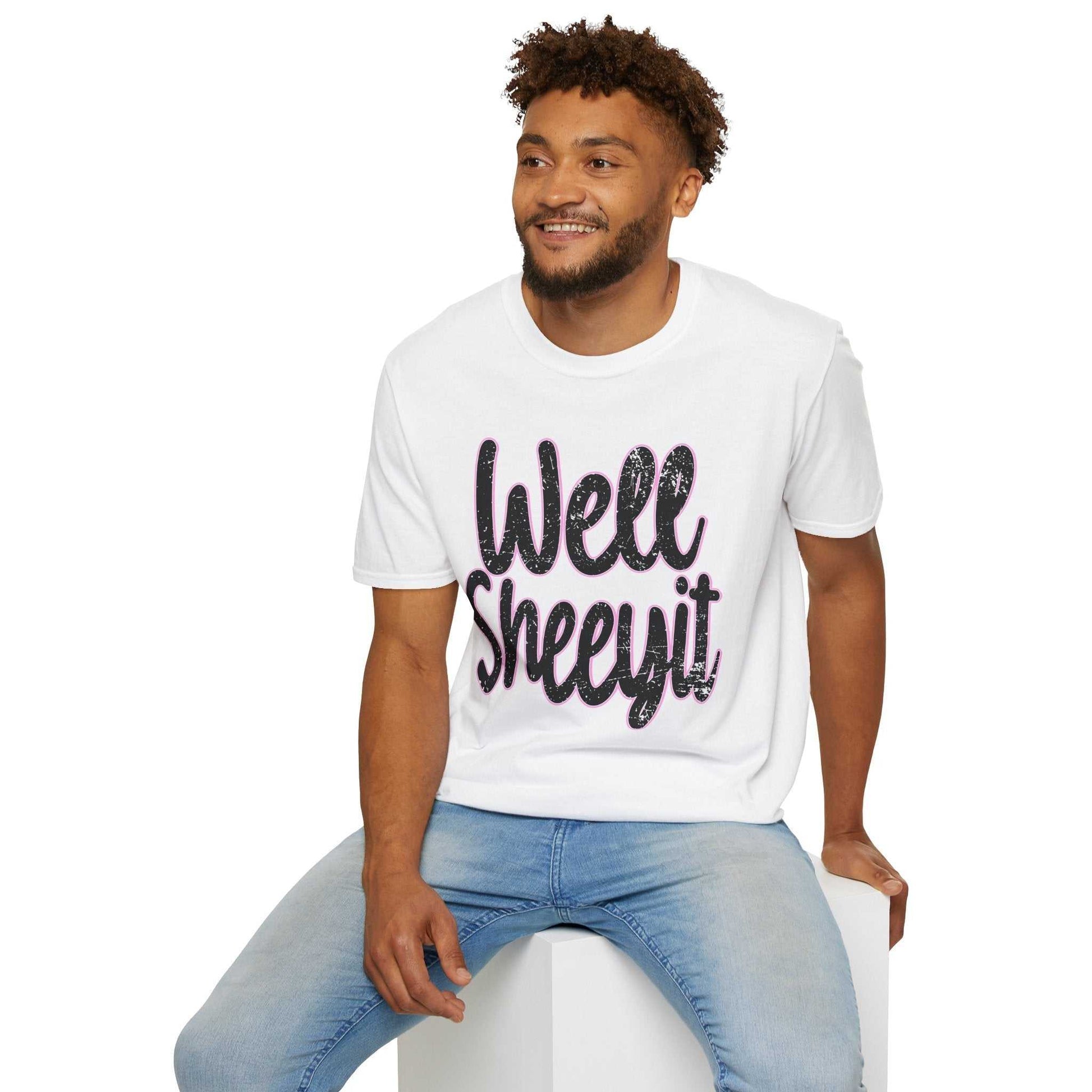 Man wearing white casual statement tee with "Well Sheeyit" funny quote sitting on a white cube against white background