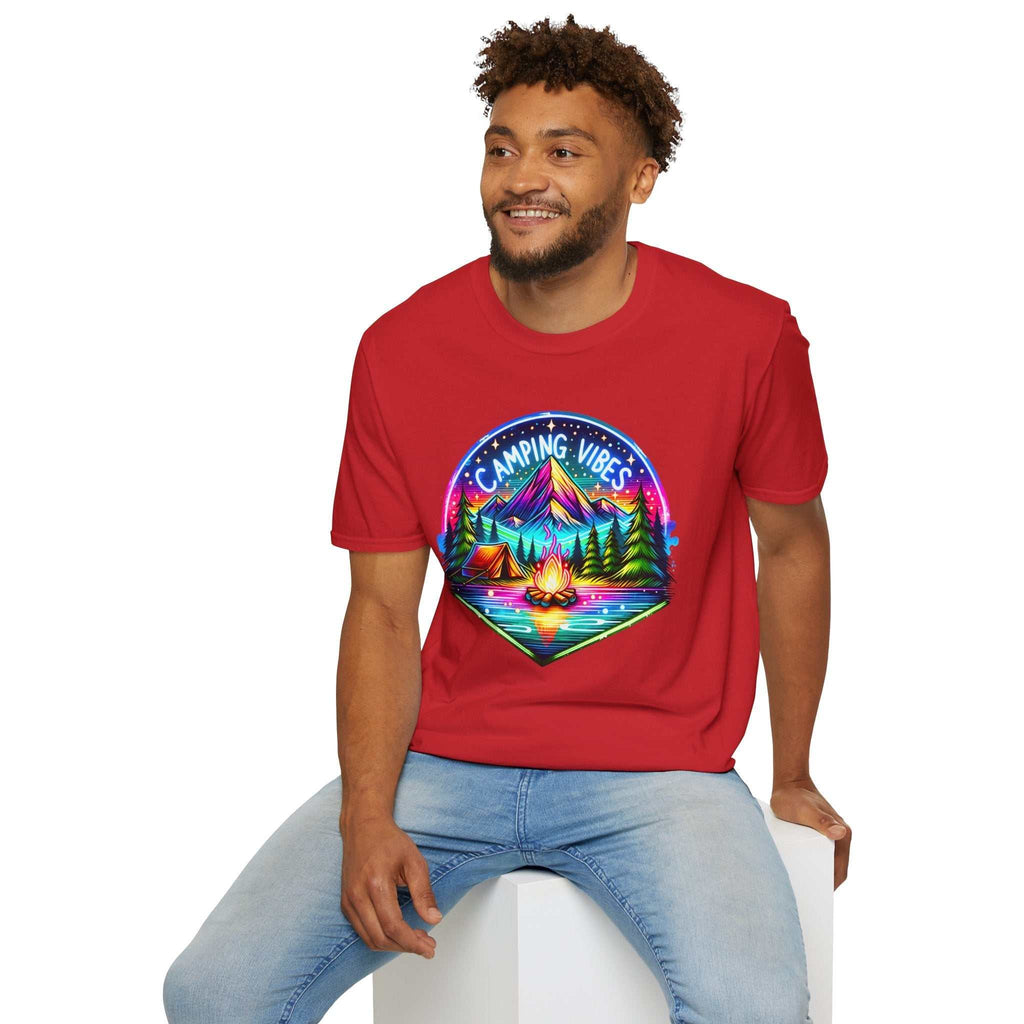 Man wearing red Camping Vibes Unisex softstyle t-shirt with colorful mountain and campfire graphic, sitting casually