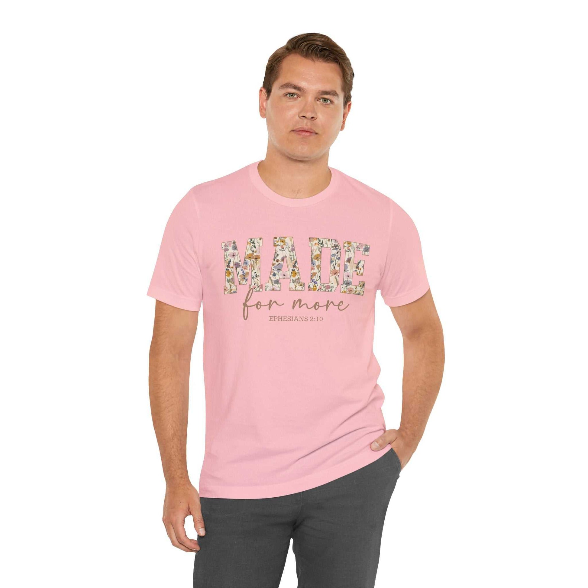 Man wearing pink Made for More Tee with floral text design and casual fit