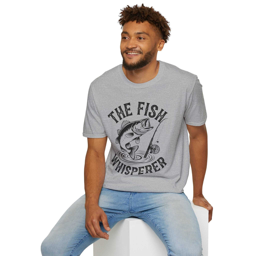 Man wearing gray unisex softstyle t-shirt with "The Fish Whisperer" fishing graphic design.