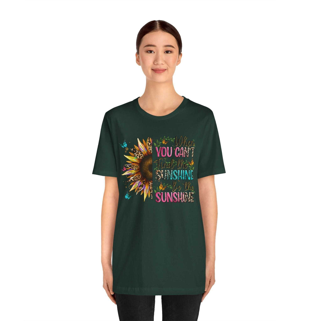 woman wearing dark green Sunshine Quote Tee with colorful sunflower and motivational text design