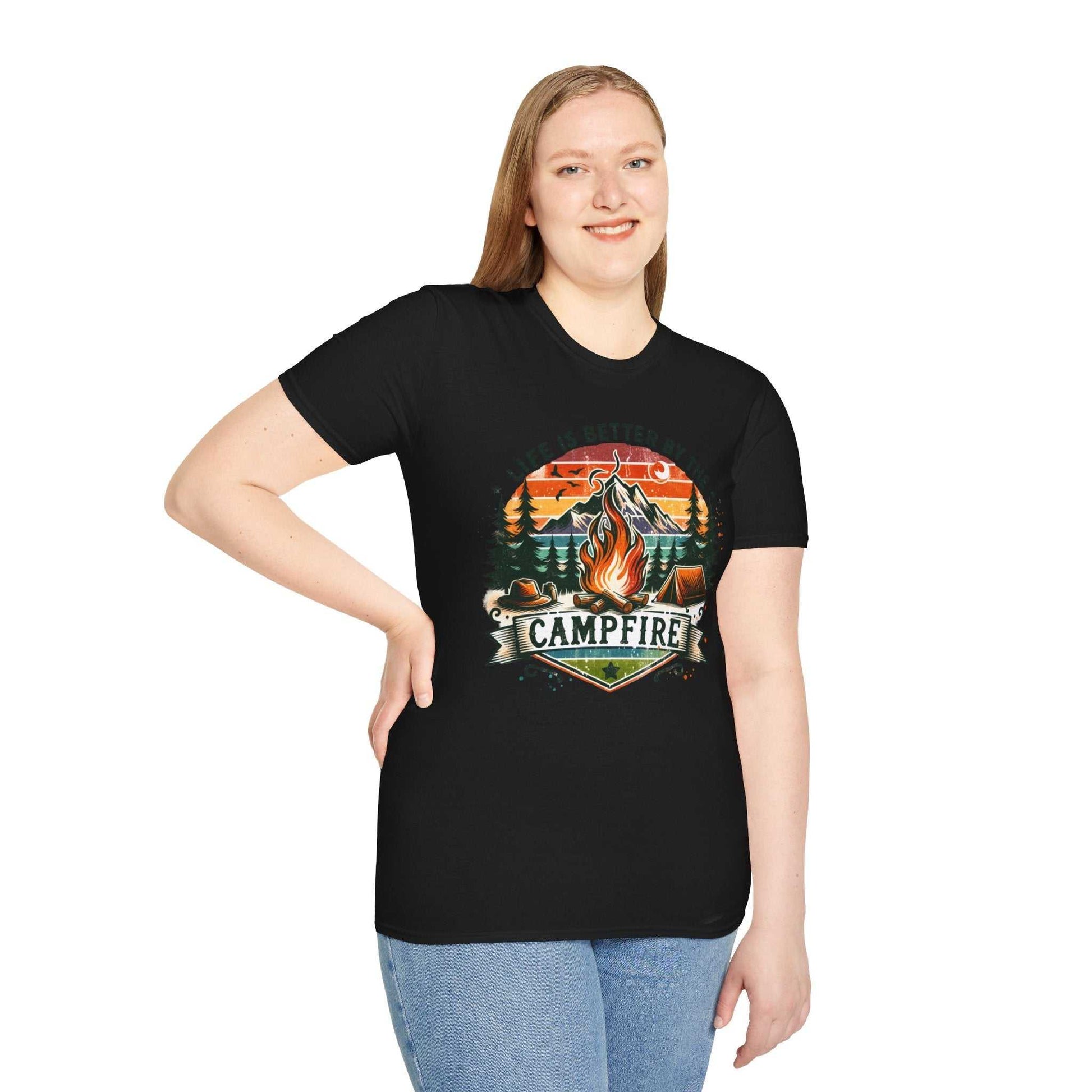 Woman wearing black Camping Adventure Unisex T-Shirt with vibrant campfire design and "Campfire" text.