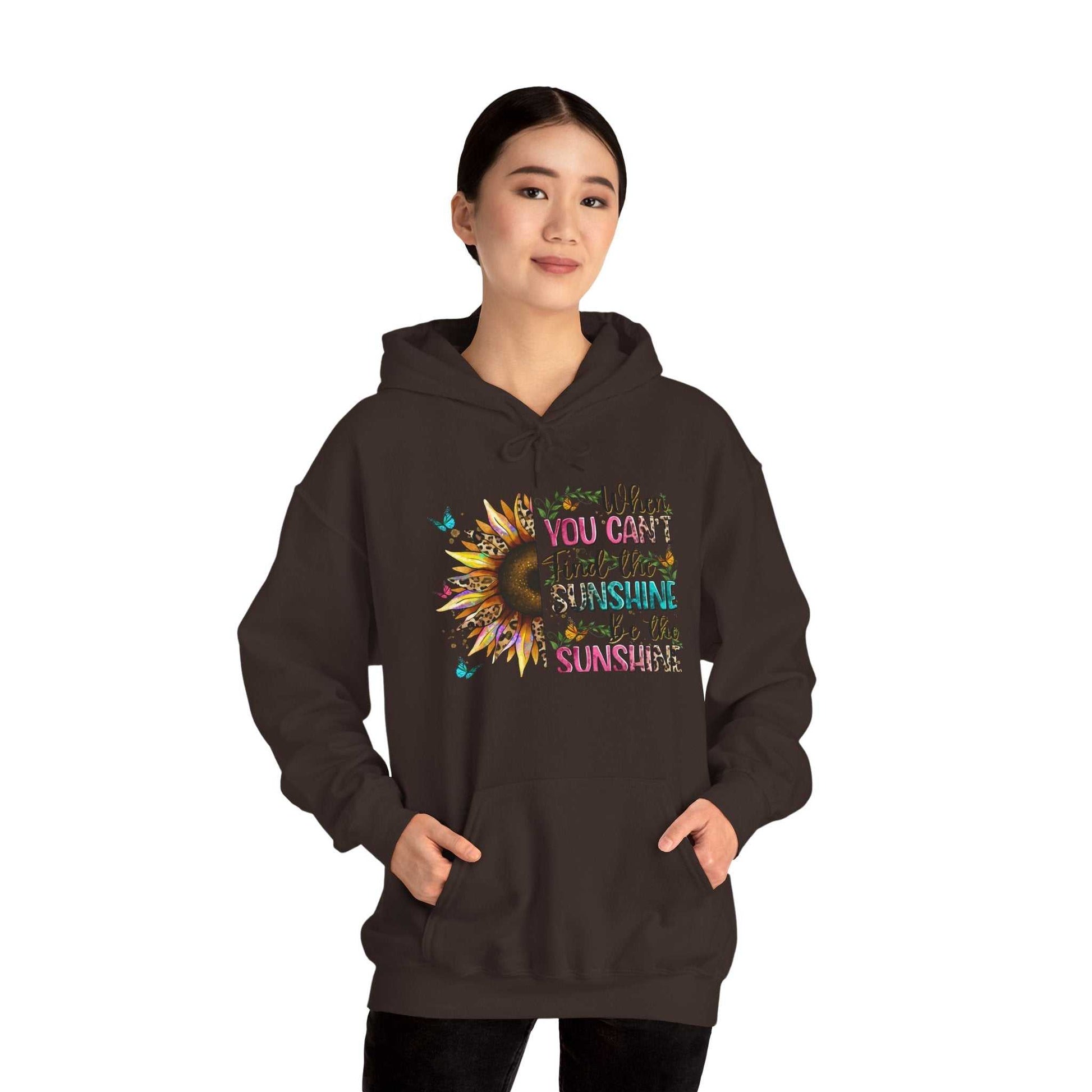Woman wearing black sunflower quote hoodie with inspirational text and kangaroo pocket