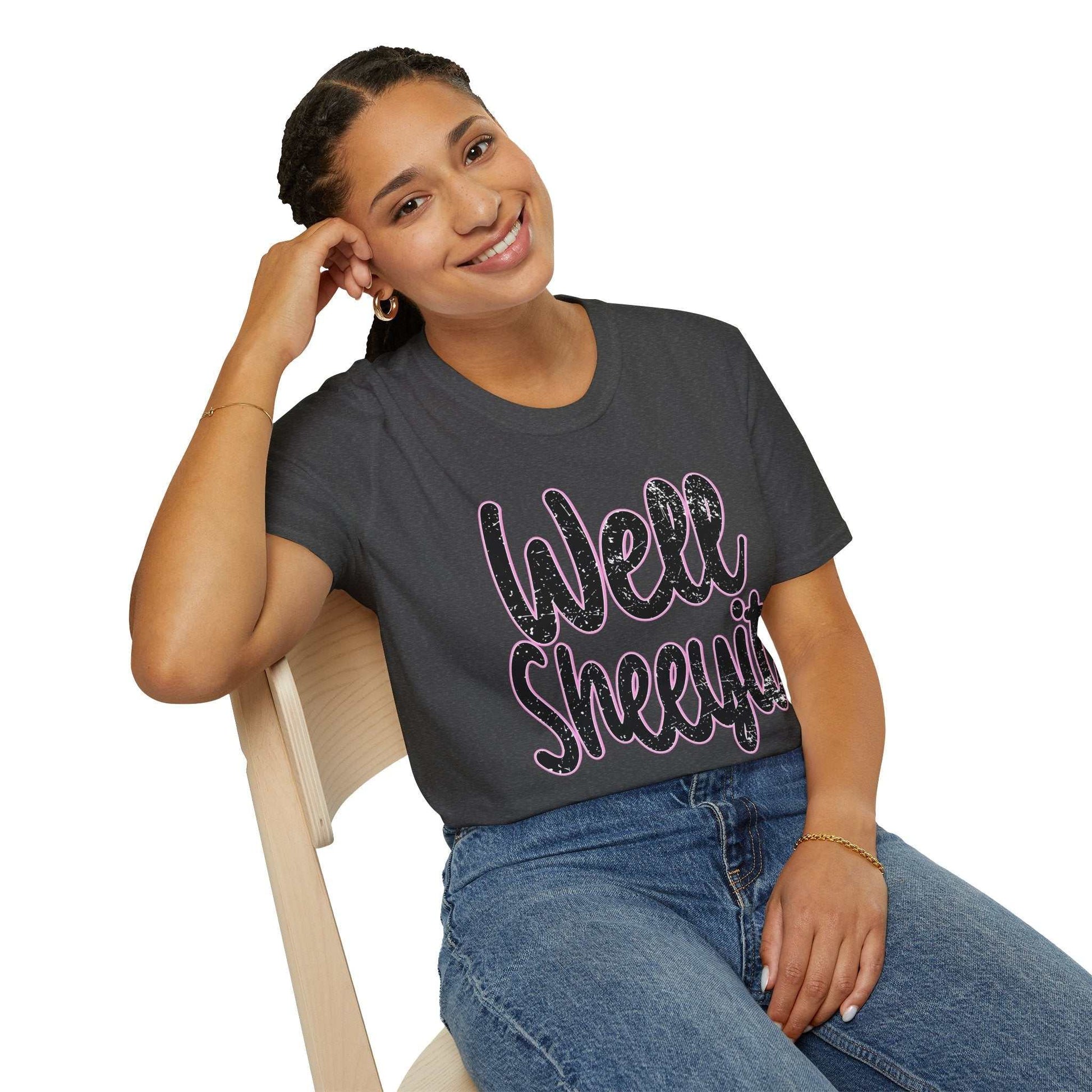 woman wearing black casual statement tee with "Well Sheeyit" funny quote sitting on wooden chair
