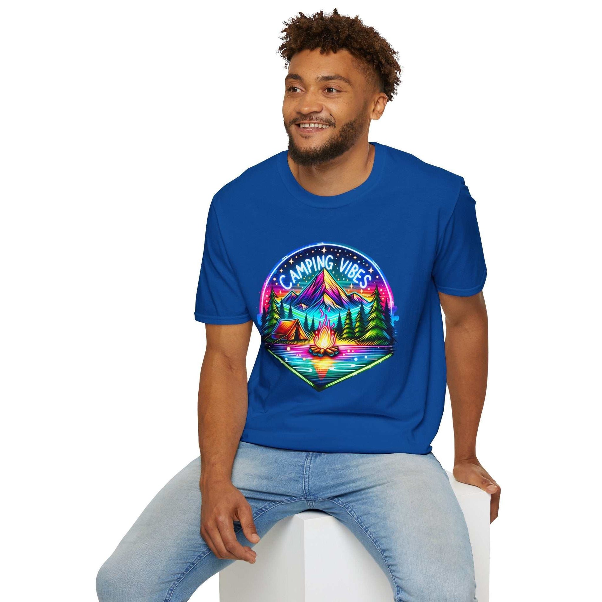 Man wearing a blue Camping Vibes unisex softstyle t-shirt with a colorful campfire and mountain design