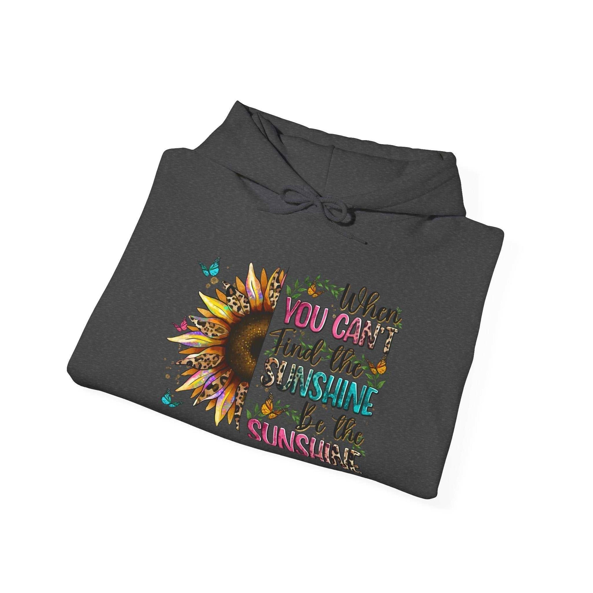 Folded dark gray sunflower quote hoodie with colorful inspirational text and sunflower graphic
