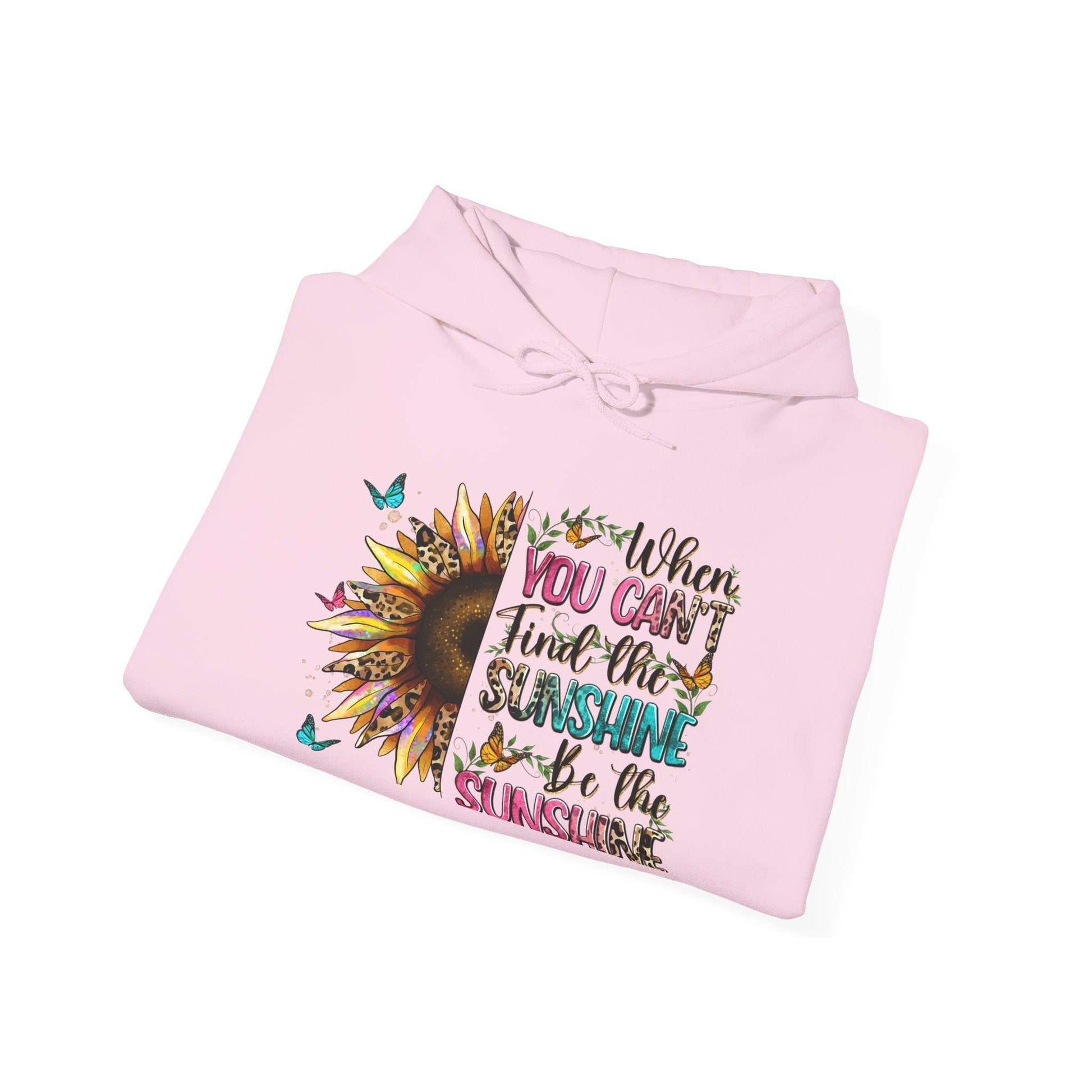 Folded pink sunflower quote hoodie with inspirational text and butterfly design