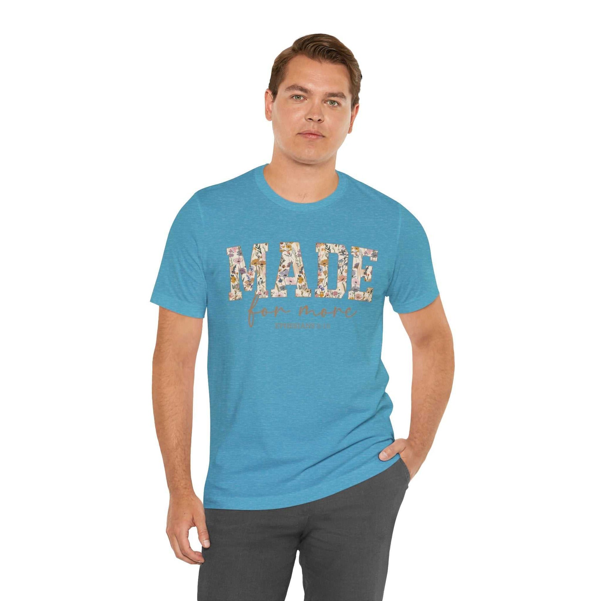 Man wearing blue Made for More Tee with floral print text on front