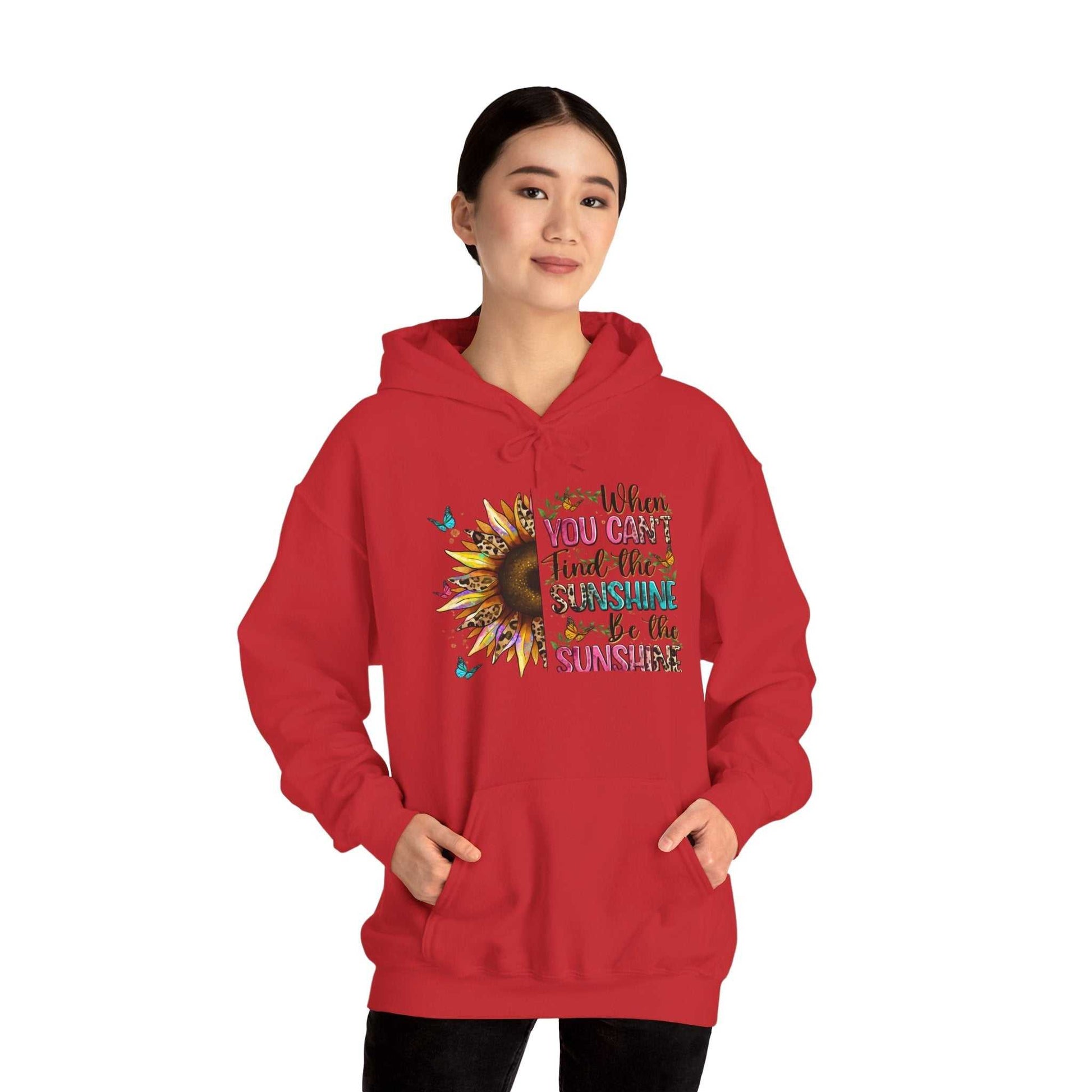 Woman wearing red sunflower quote hoodie with inspirational sunshine message and kangaroo pocket