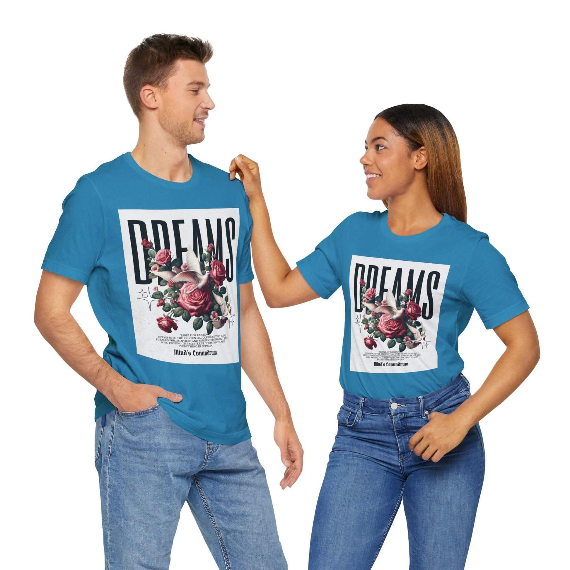 Man and woman wearing blue Dreams Floral Tee with bold floral graphic and typography, styled casually with jeans.