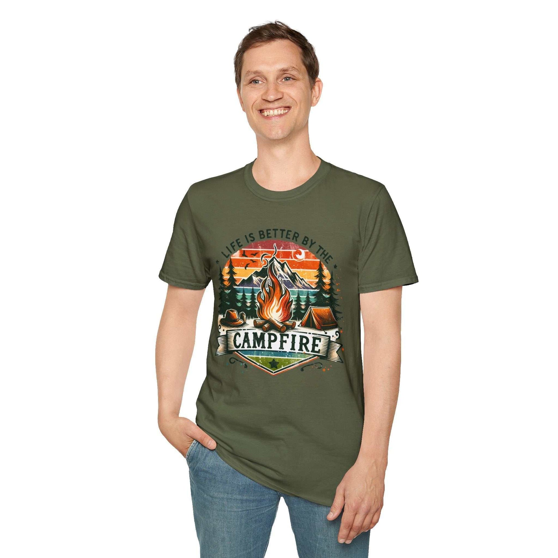 Camping Adventure Unisex T-Shirt in olive green with campfire graphic and "Life is Better by the Campfire" text, worn by smiling man