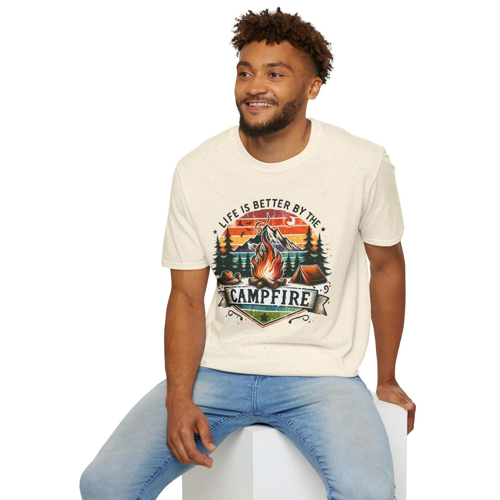 Man wearing Camping Adventure Unisex T-Shirt with campfire design and "Life is Better by the Campfire" text