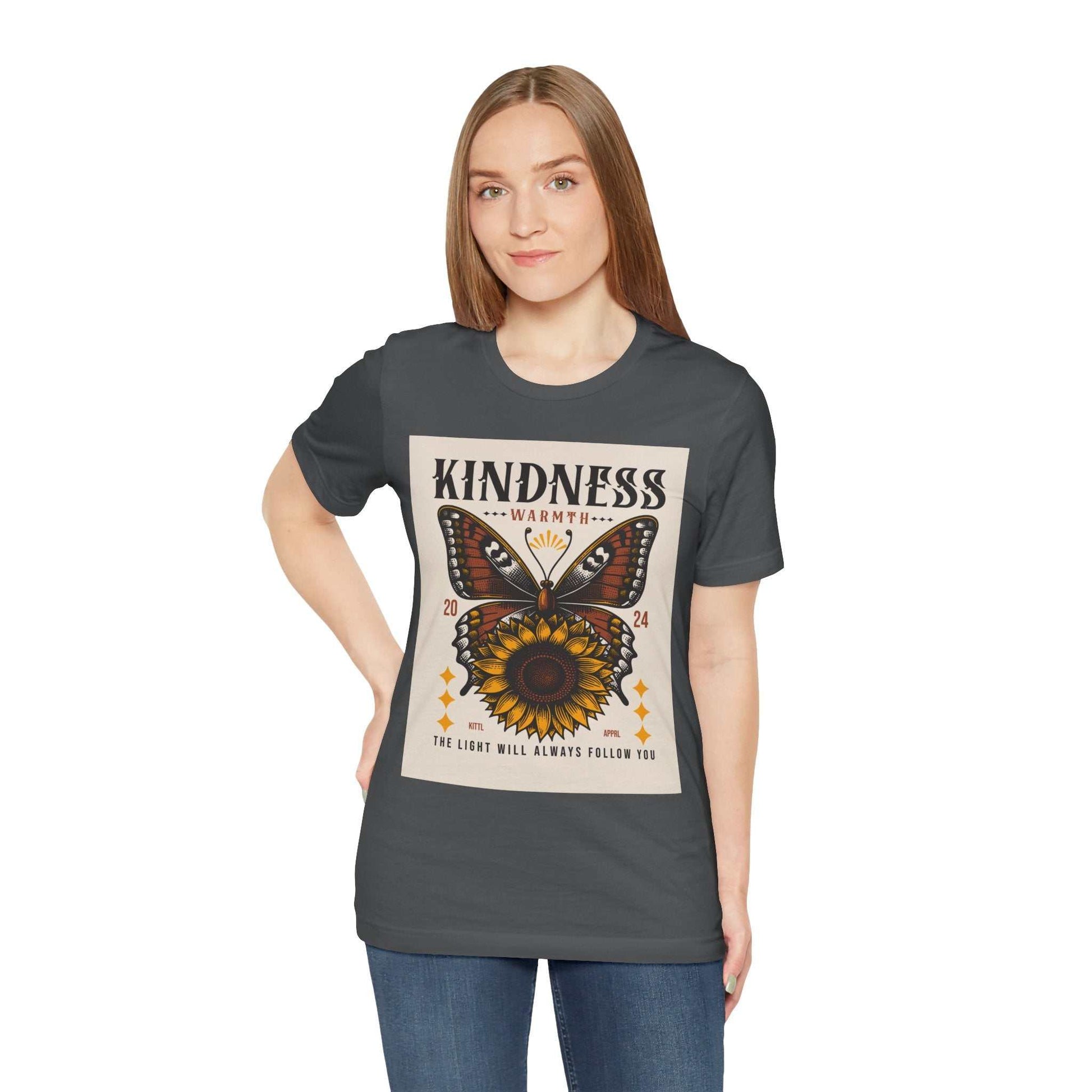 Woman wearing charcoal Kindness Butterfly Tee with butterfly and sunflower design and text "Kindness Warmth"