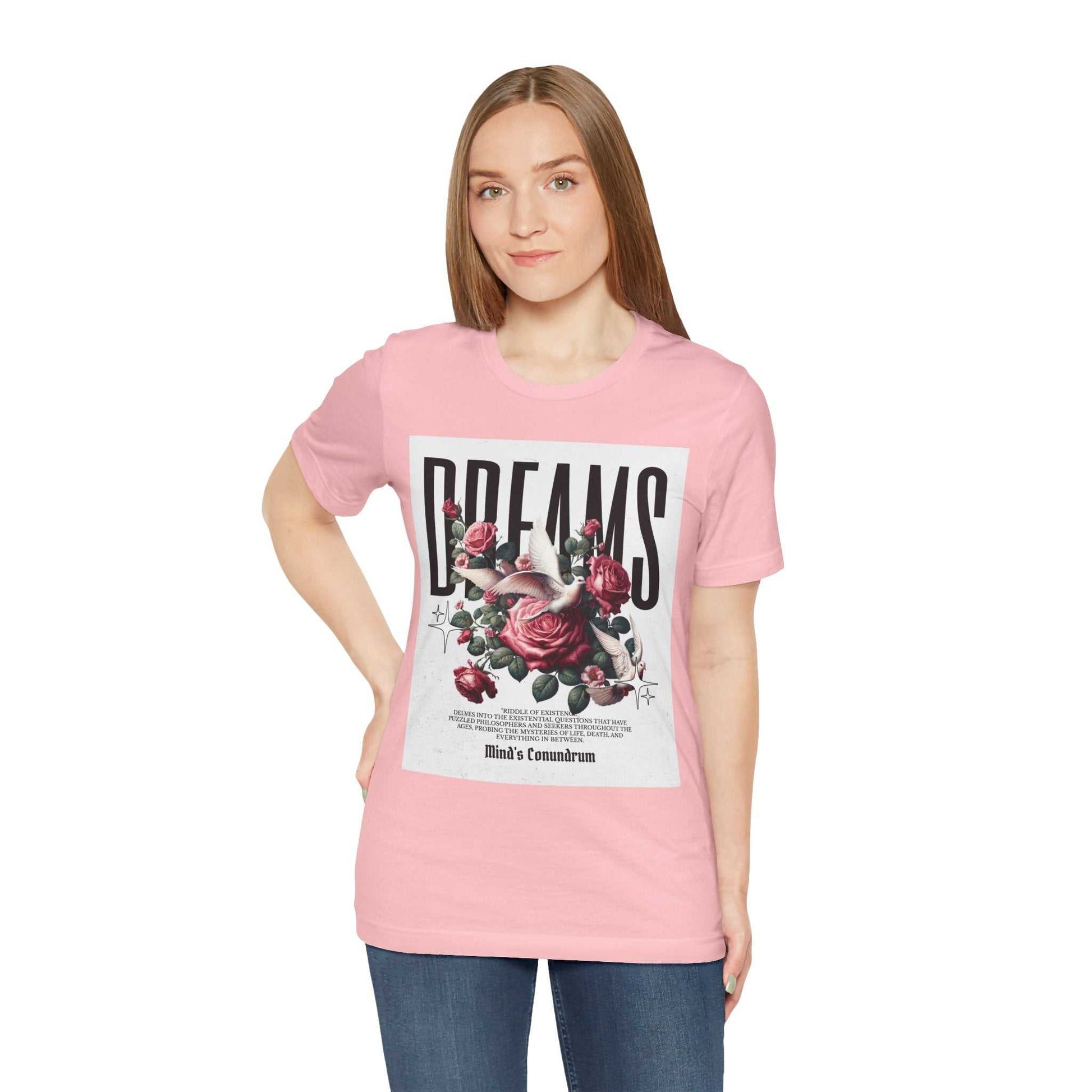 Woman wearing pink Dreams Floral Tee with large floral and typography design on front
