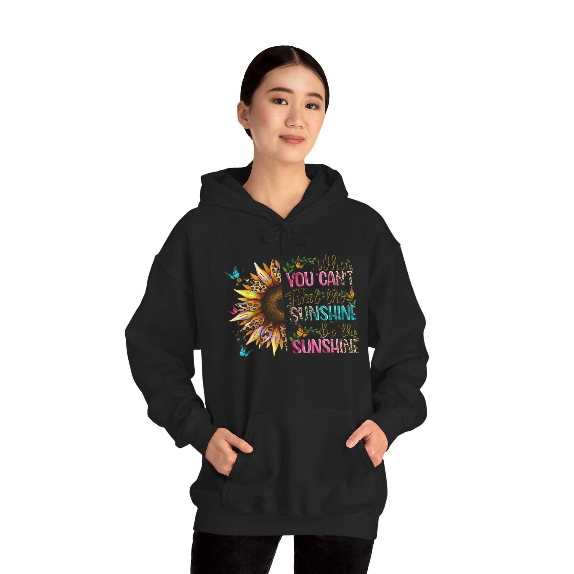 Black sunflower quote hoodie with colorful inspirational text worn by woman