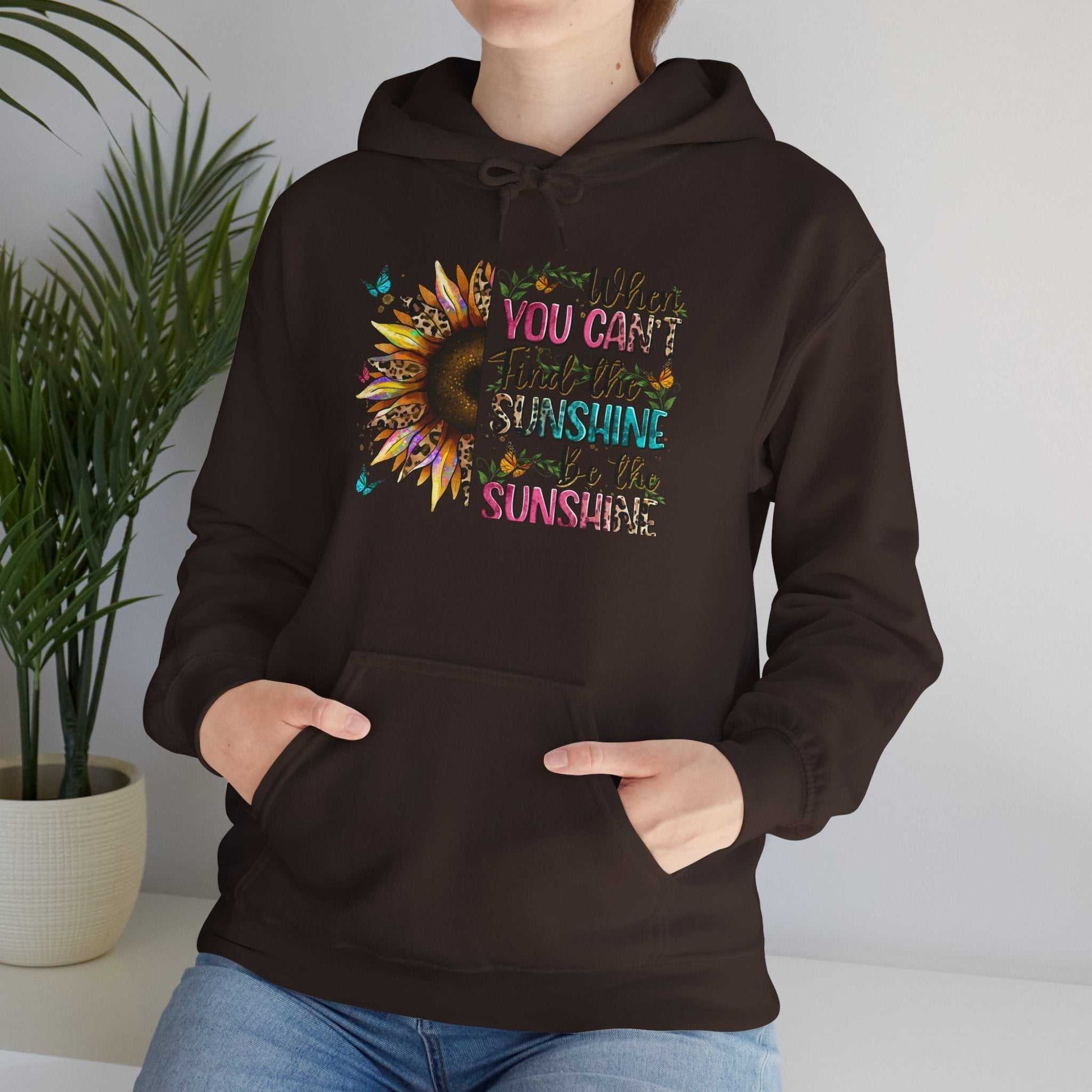 Black unisex sunflower quote hoodie with colorful inspirational text and kangaroo pocket, cozy cotton-poly blend sweatshirt.