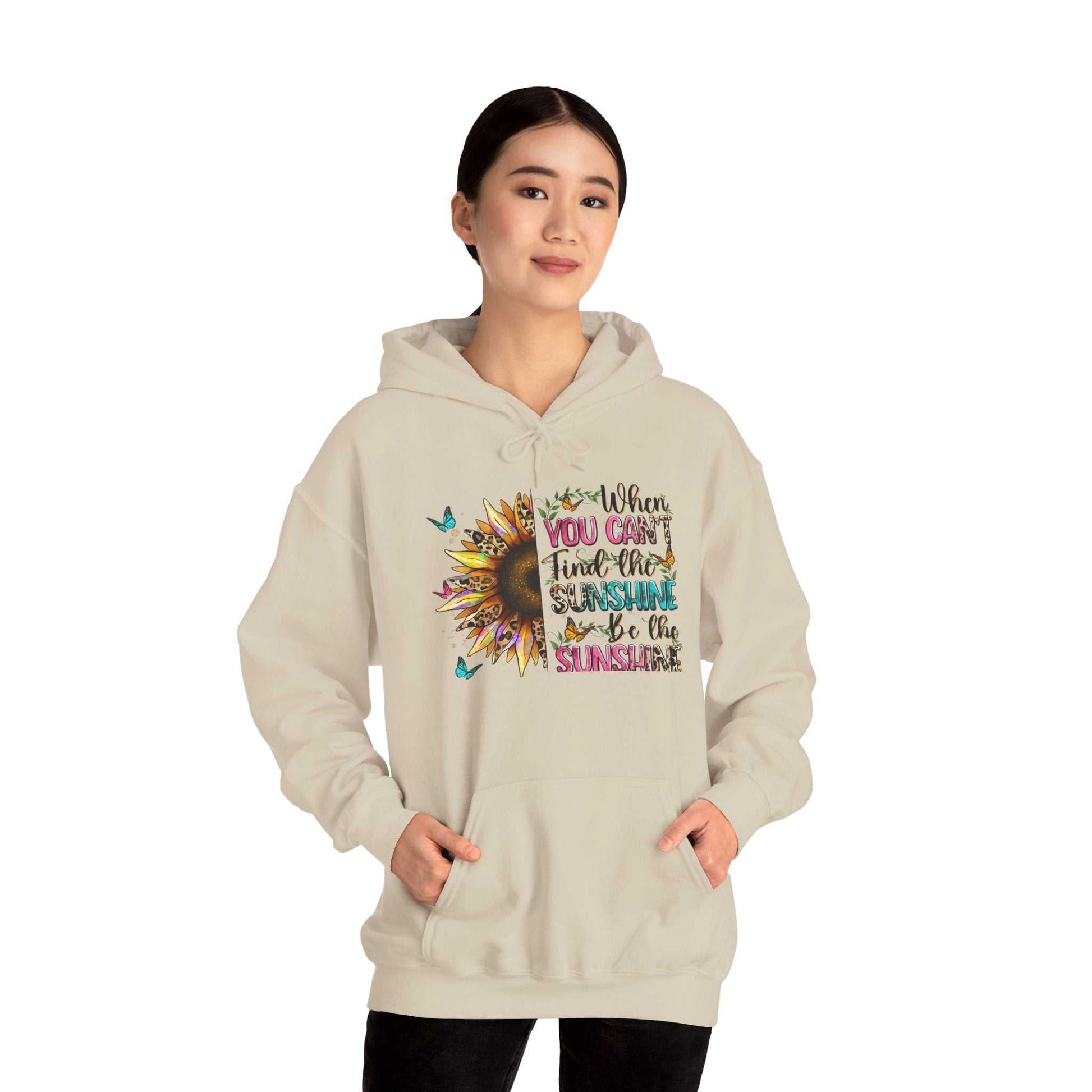 Woman wearing beige sunflower quote hoodie with inspirational message and kangaroo pocket