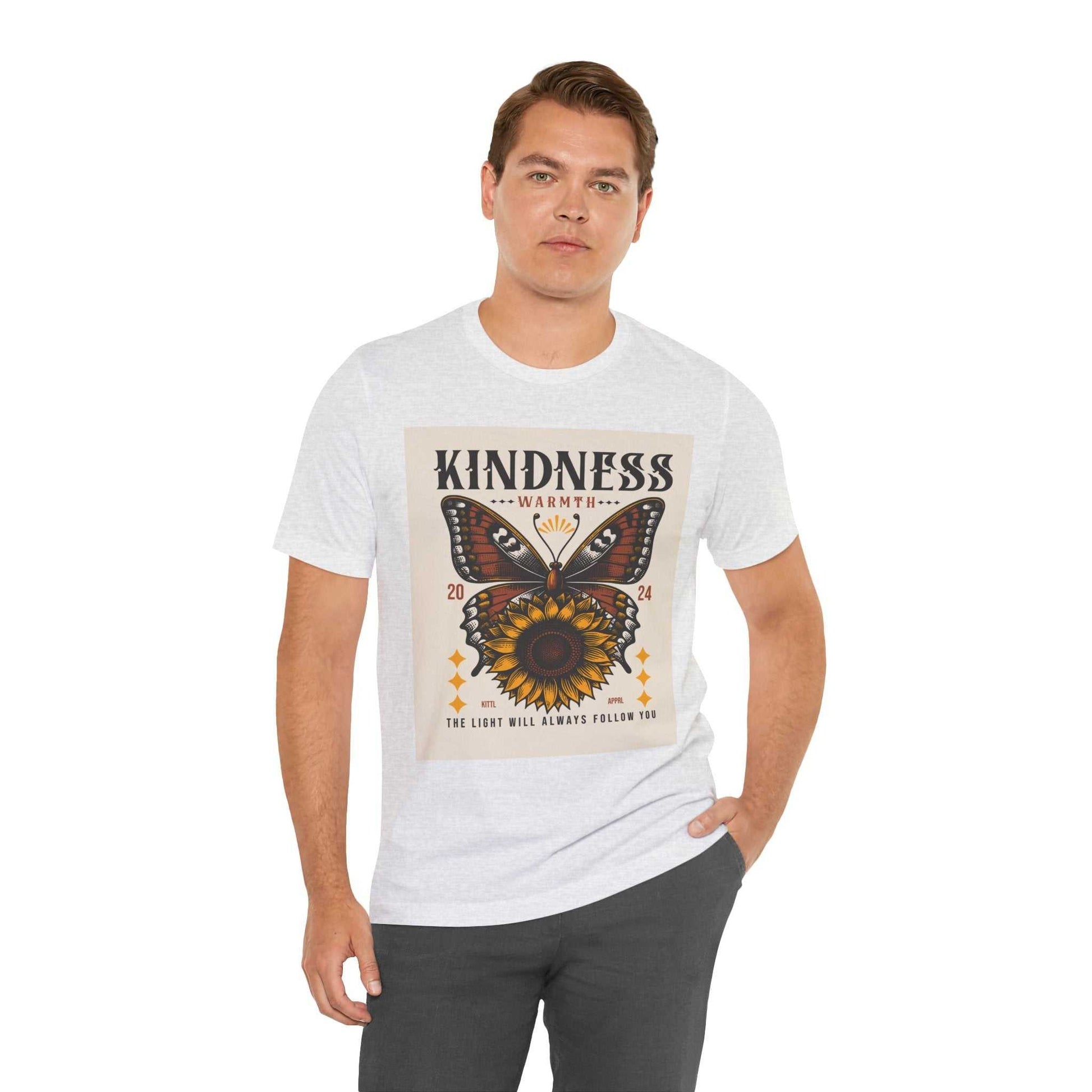 Man wearing white Kindness Butterfly Tee with butterfly and sunflower graphic and positive message on front