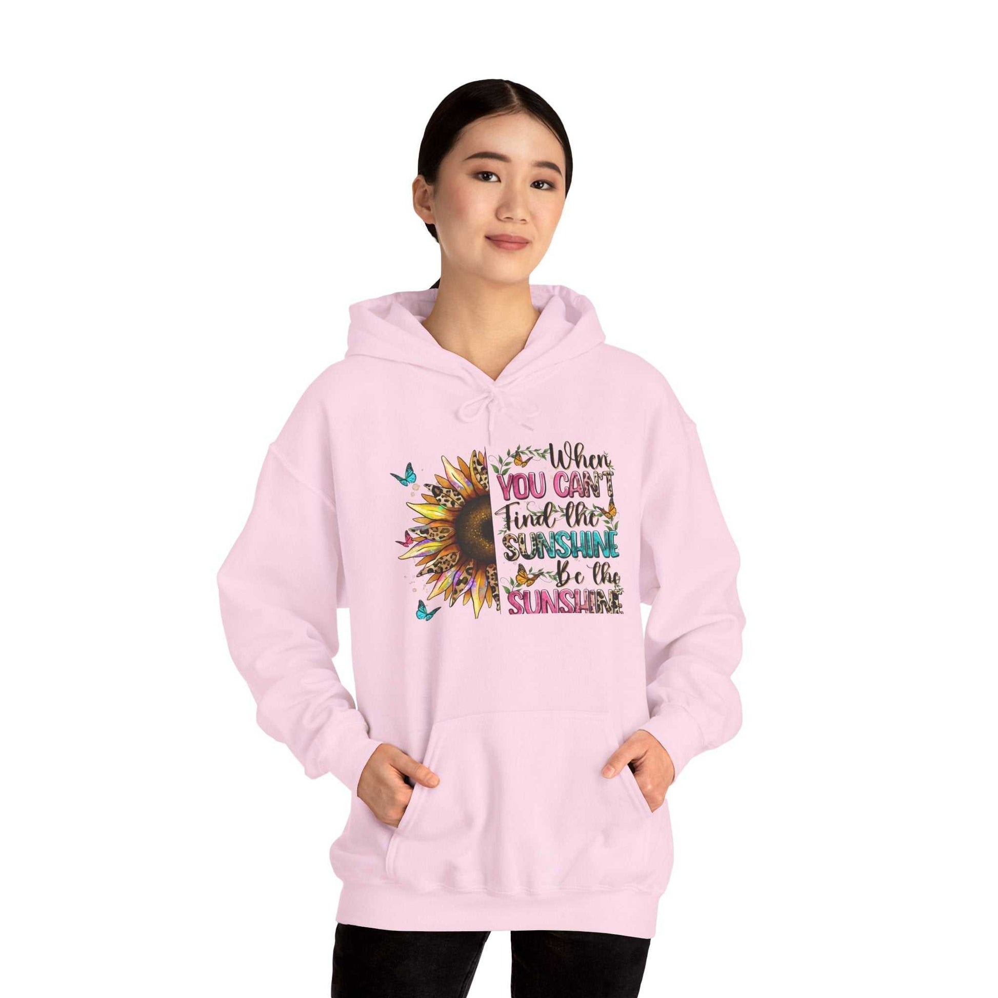 Woman wearing pink sunflower quote hoodie with inspirational text and butterfly design
