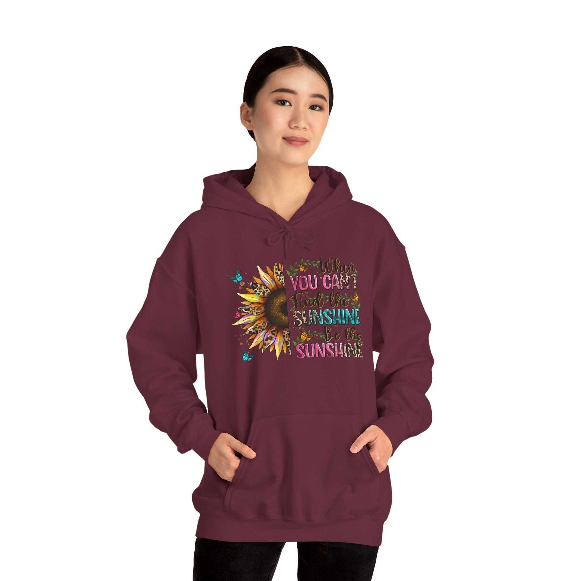 Woman wearing maroon Sunflower Quote Hoodie with inspirational sunflower design and uplifting text on front