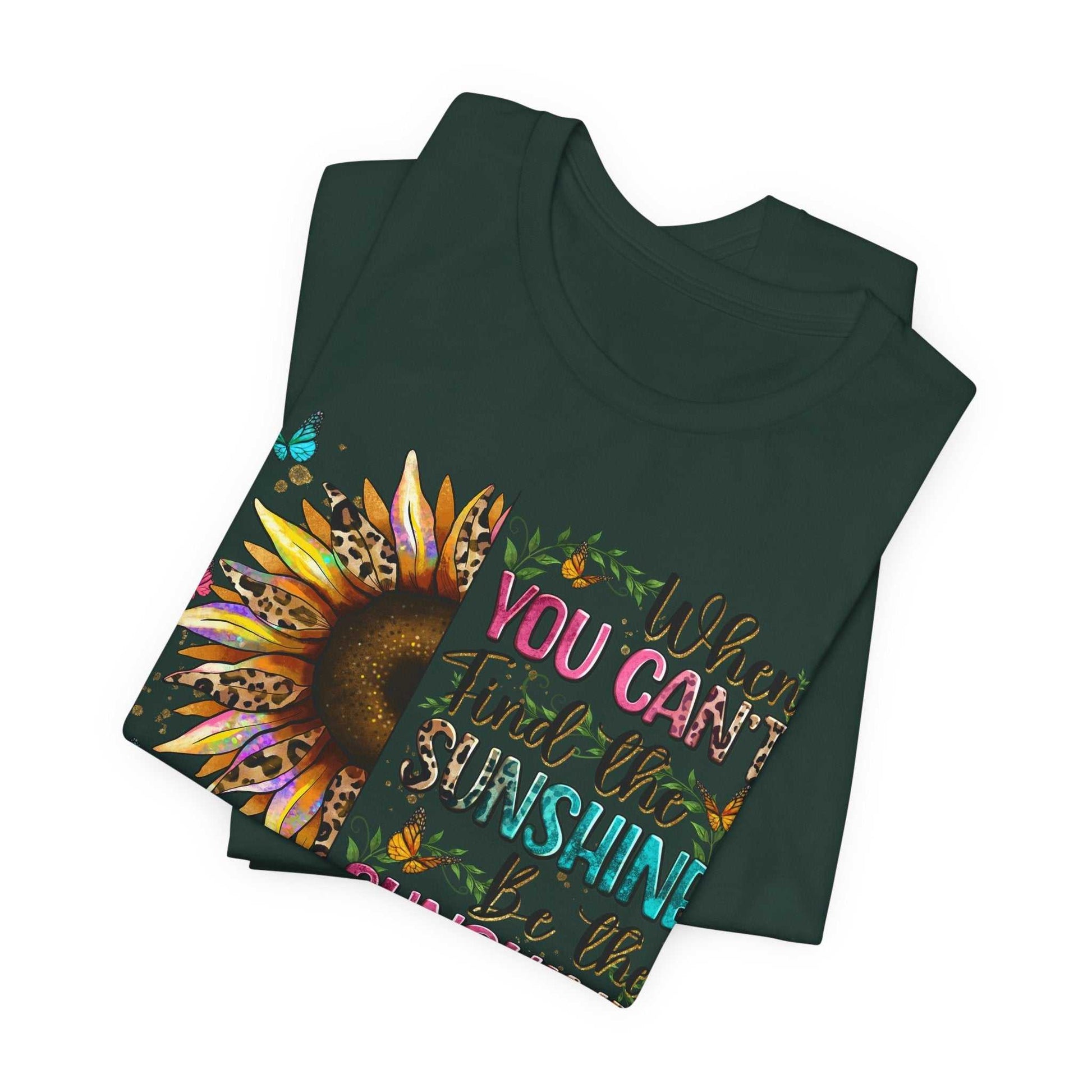 Folded black Sunshine Quote Tee with colorful sunflower and inspirational text design