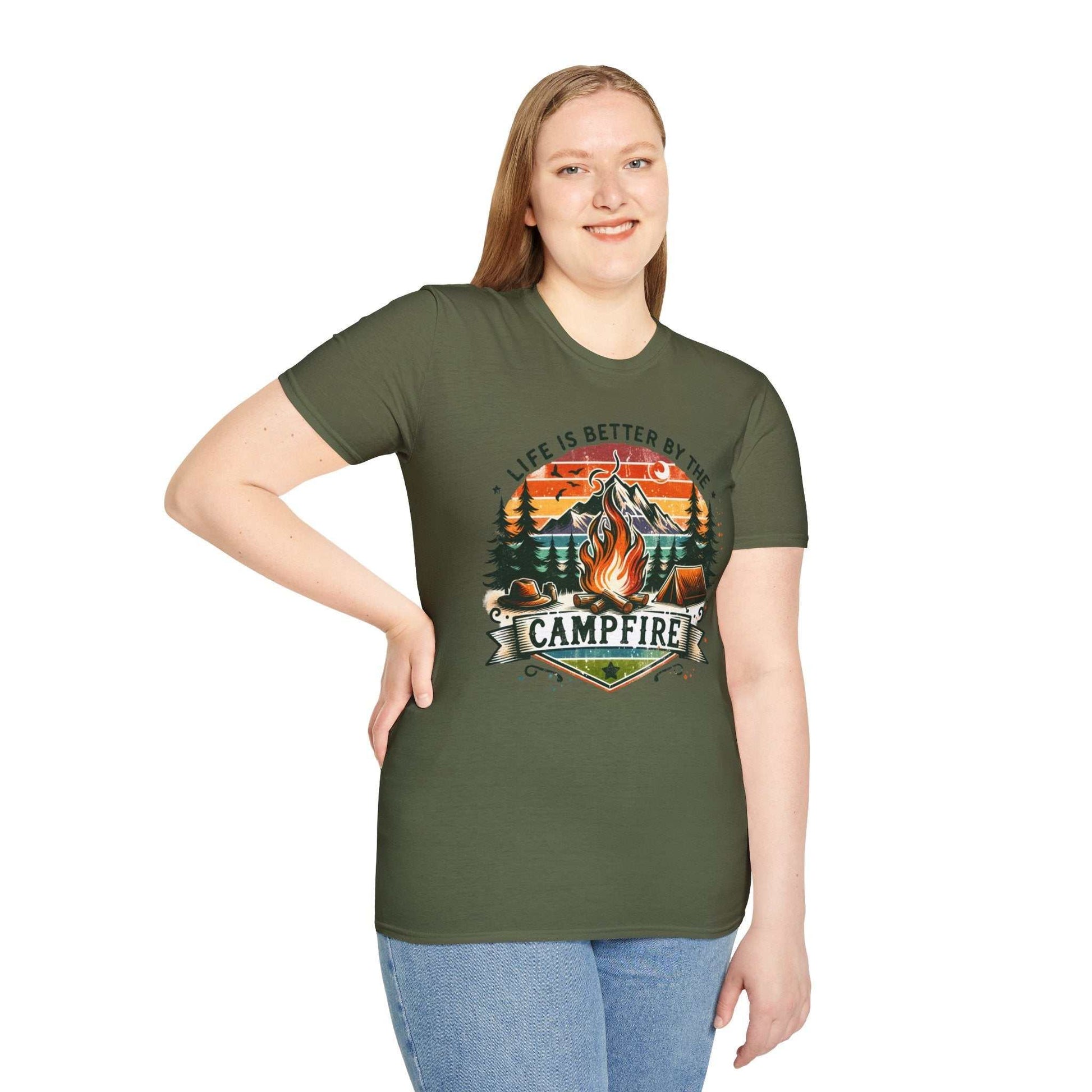 Unisex green Camping Adventure T-shirt with campfire graphic and "Life is Better by the Campfire" text, modeled by a smiling person.