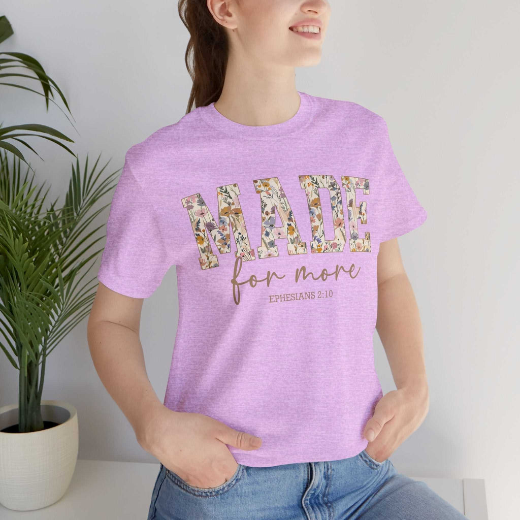Woman wearing a lavender "Made for More" floral print unisex jersey short sleeve tee with relaxed fit and ribbed collar.