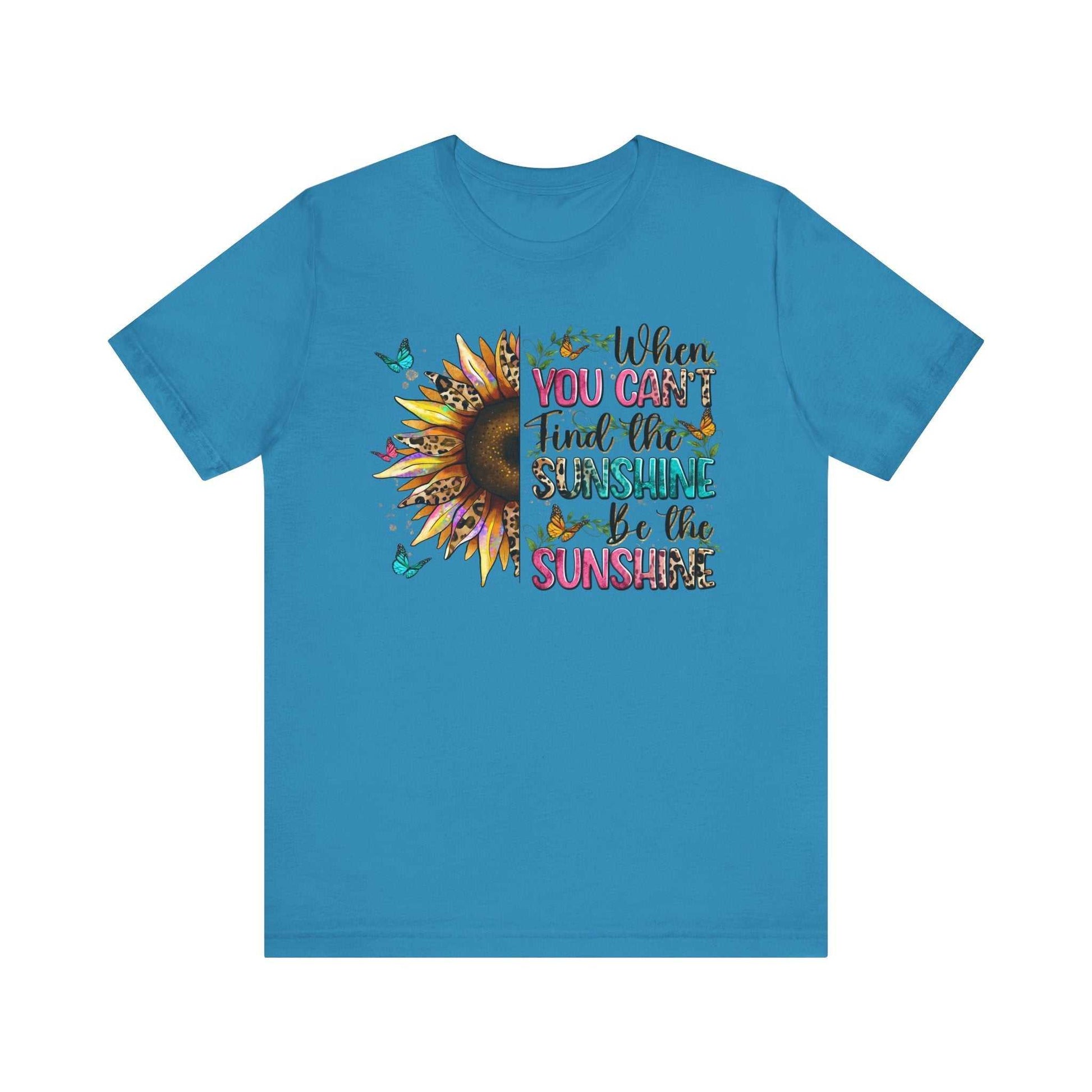 Blue unisex Sunshine Quote Tee with vibrant sunflower and positive message print.